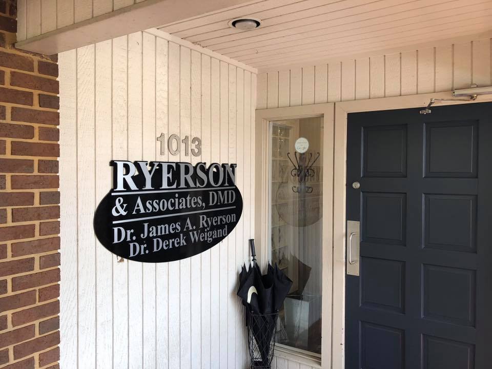 A sign on the side of a building says ryerson & associates dmd