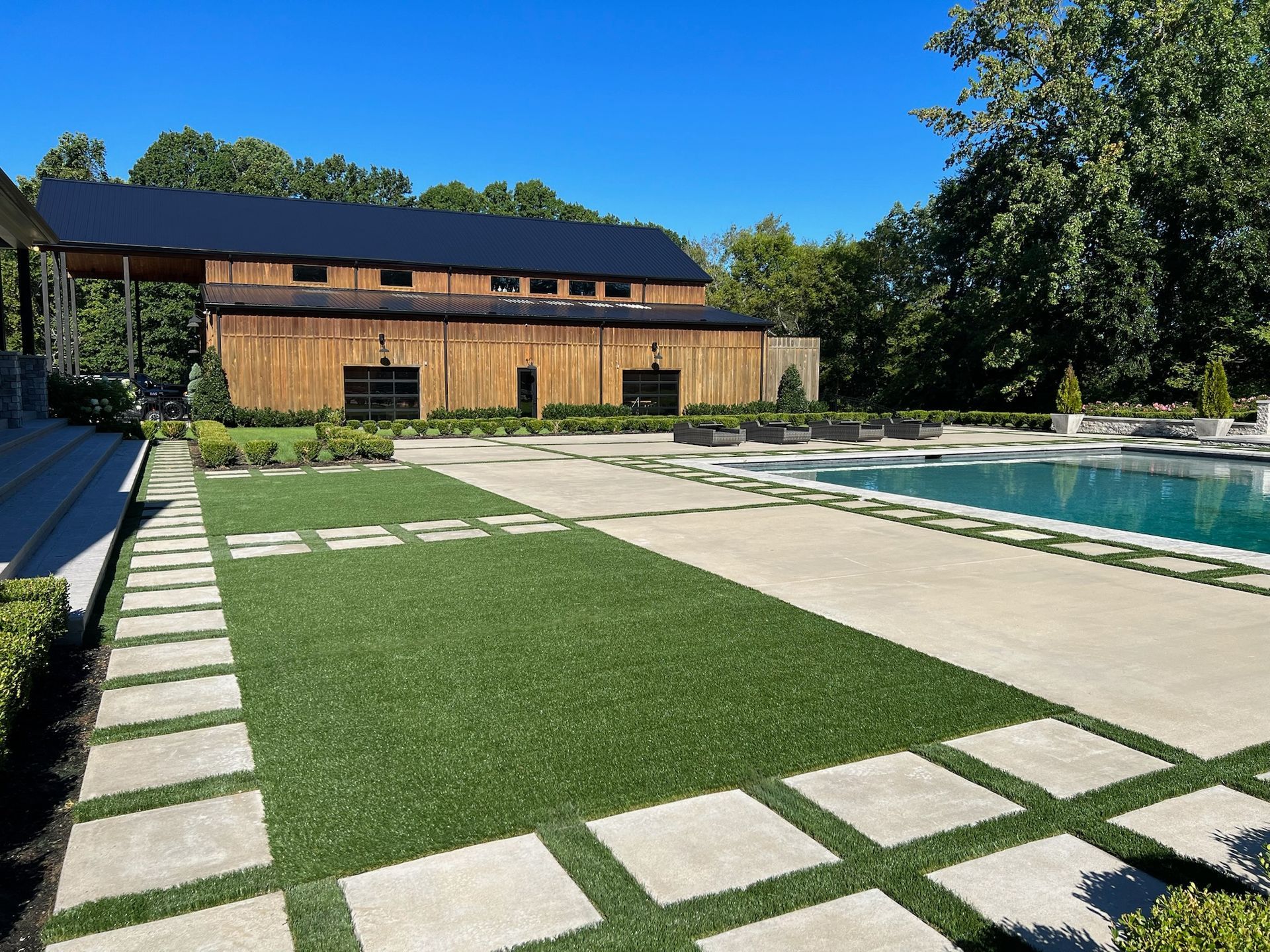 A large house with a swimming pool in front of it