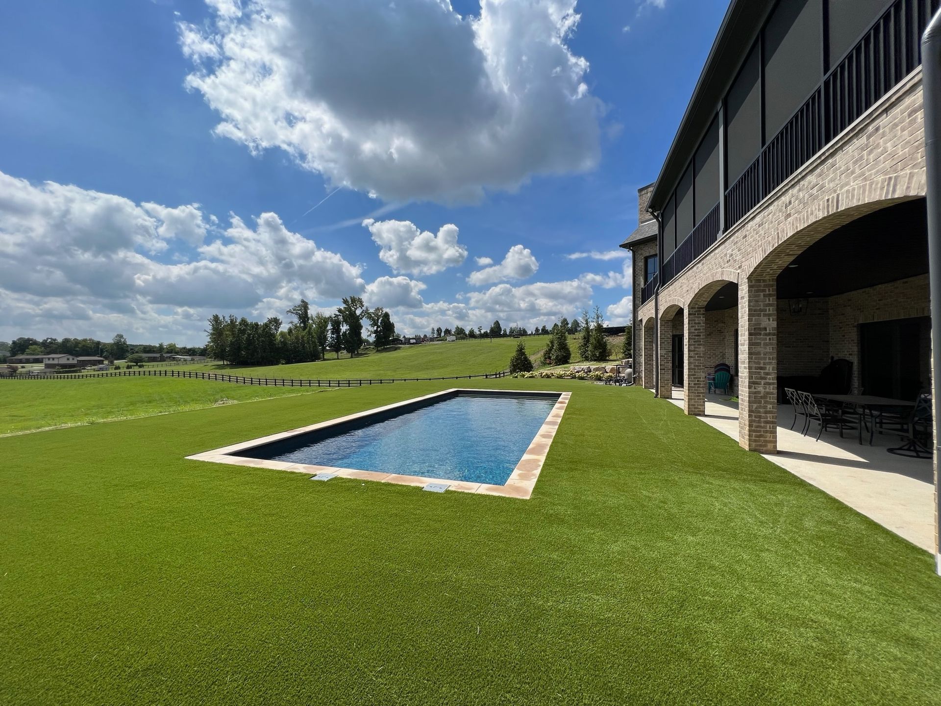 A large house with a large swimming pool in the backyard.