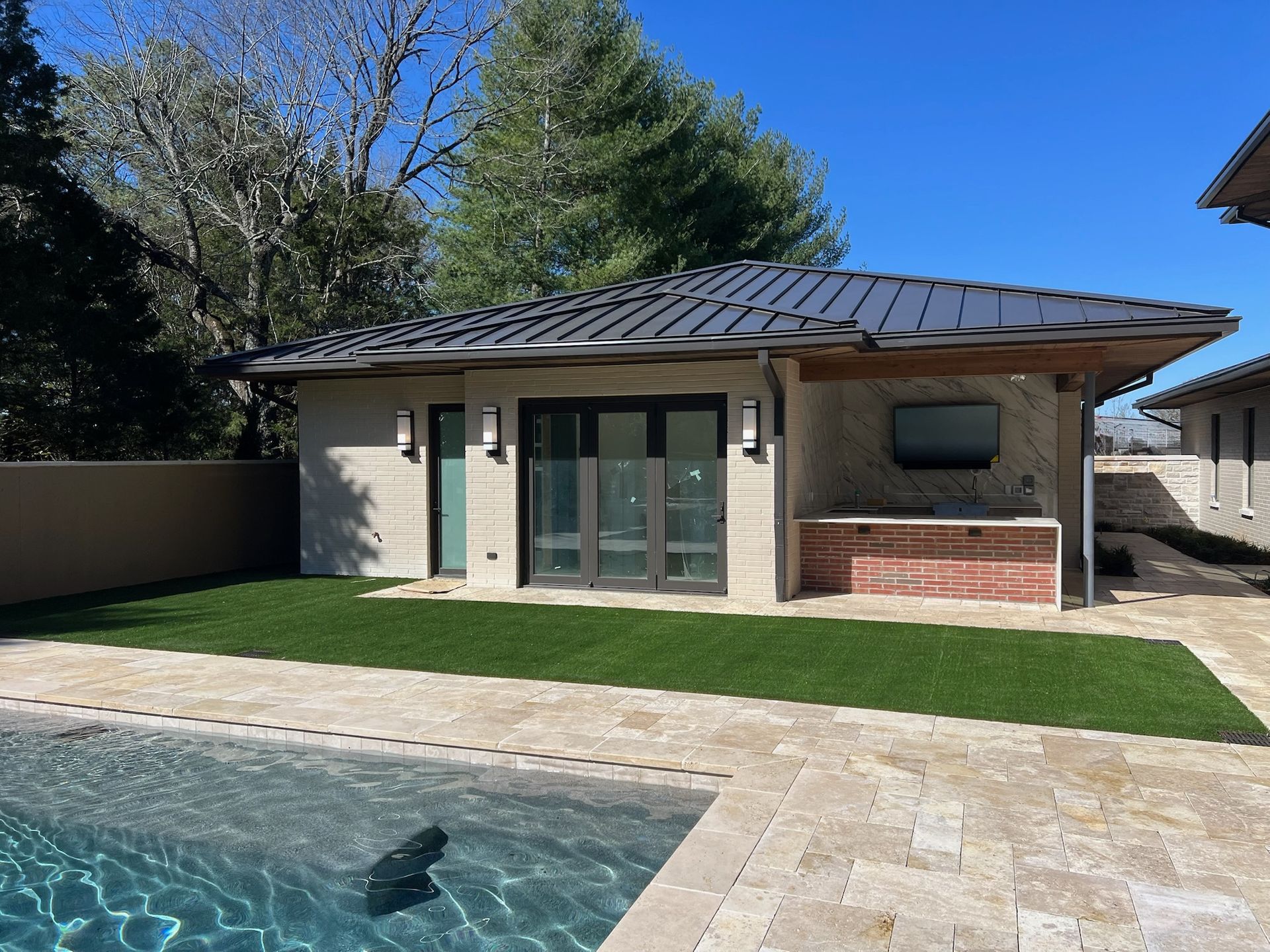 A house with a swimming pool in front of it
