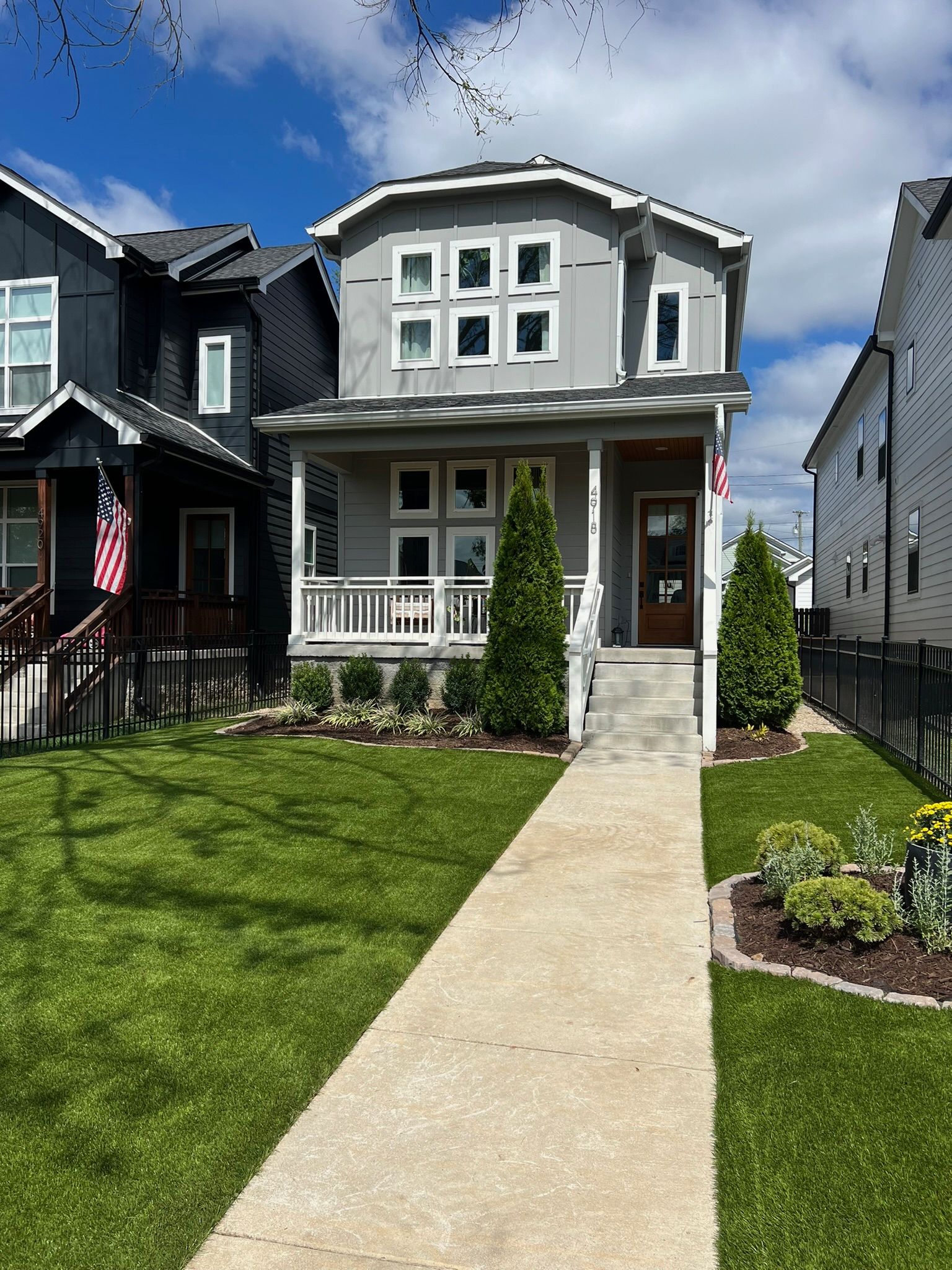 A house with a porch and a walkway leading to it.