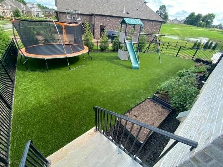 An aerial view of a backyard with a trampoline and a slide.