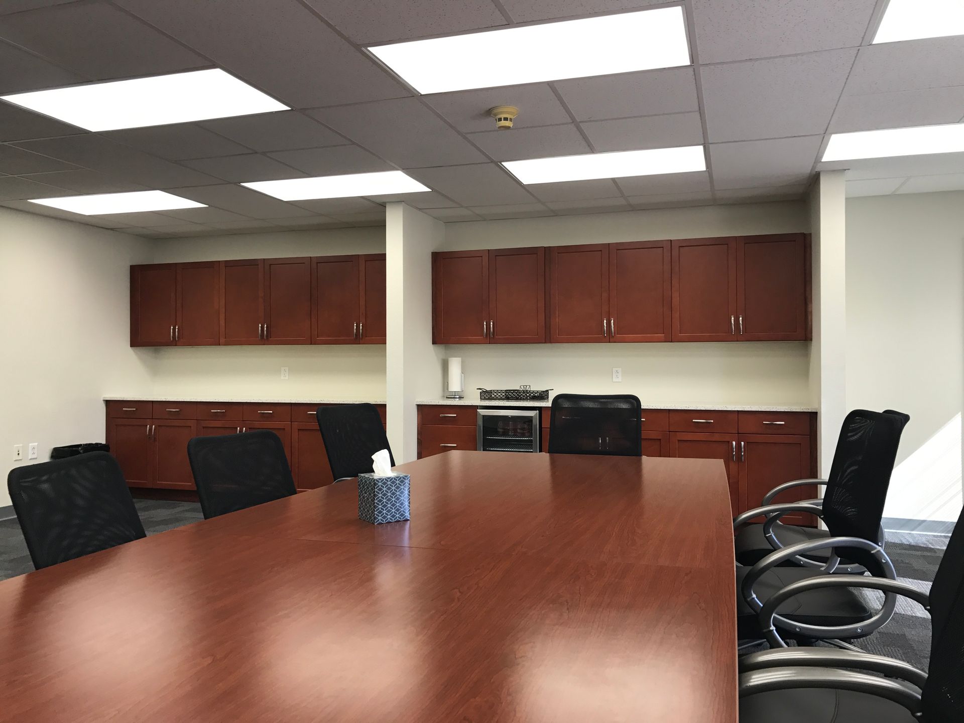 a conference room with a long wooden table and chairs