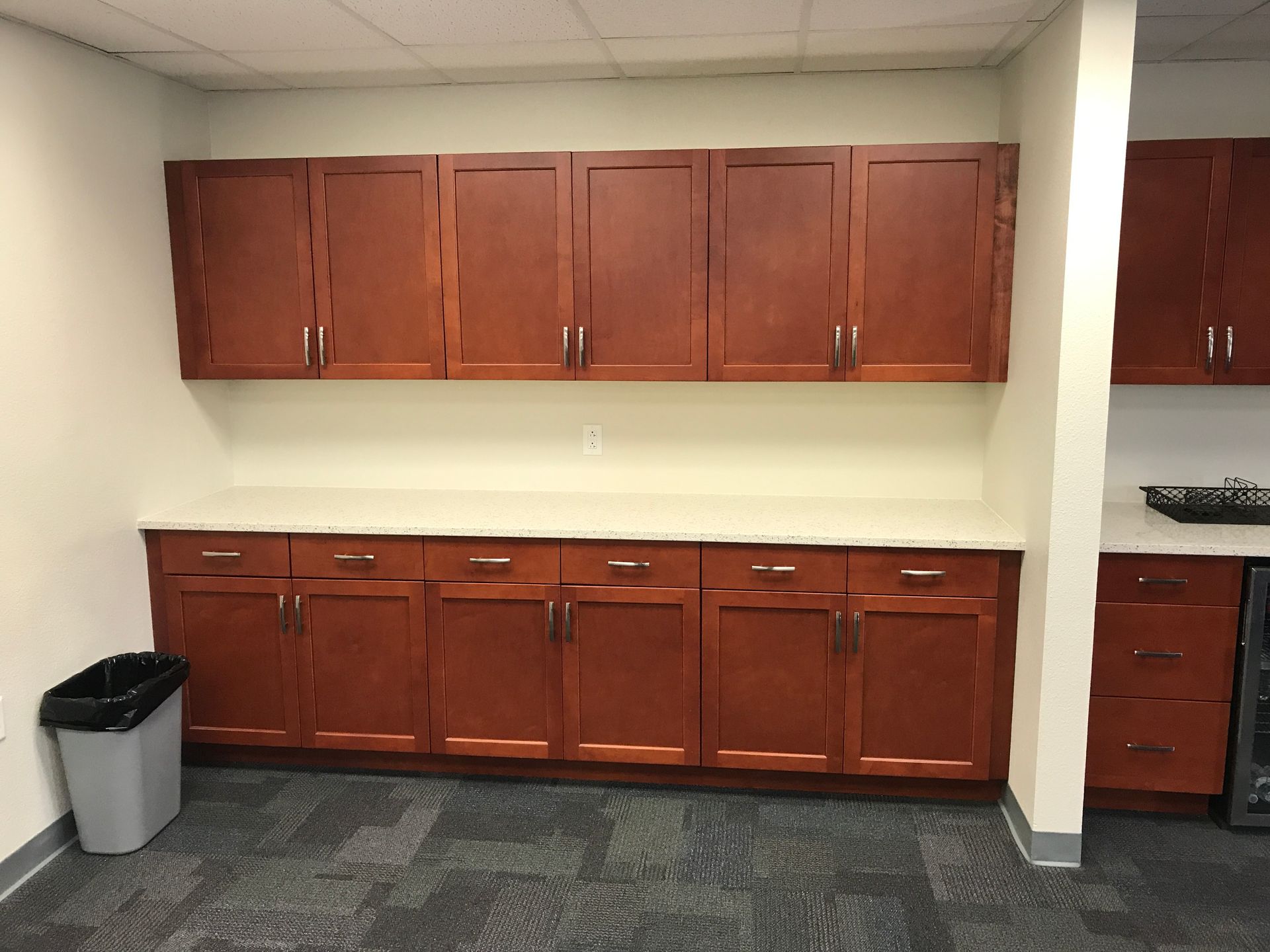 wooden cabinets and a trash can