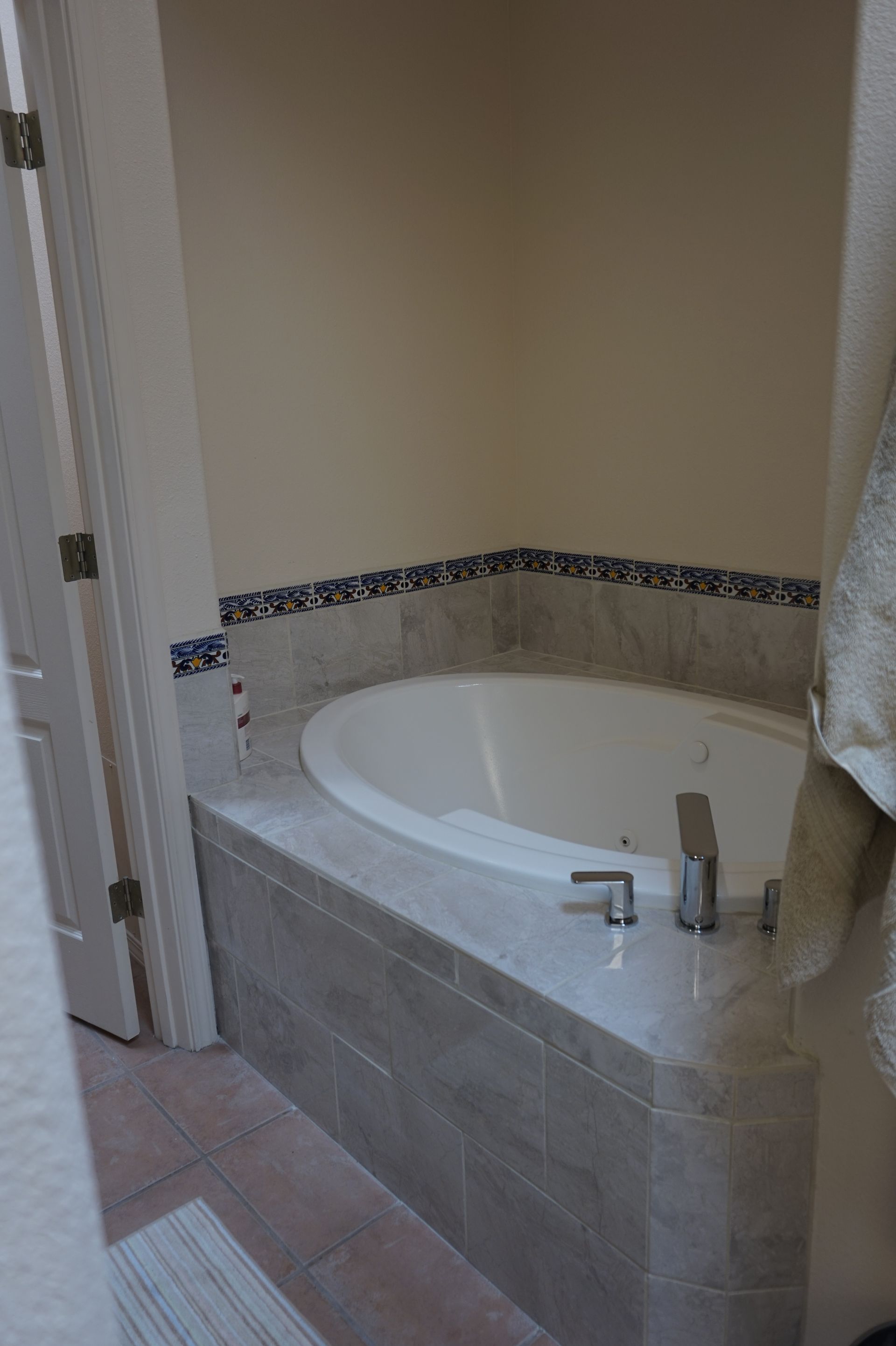 there is a bathtub in the corner of the bathroom