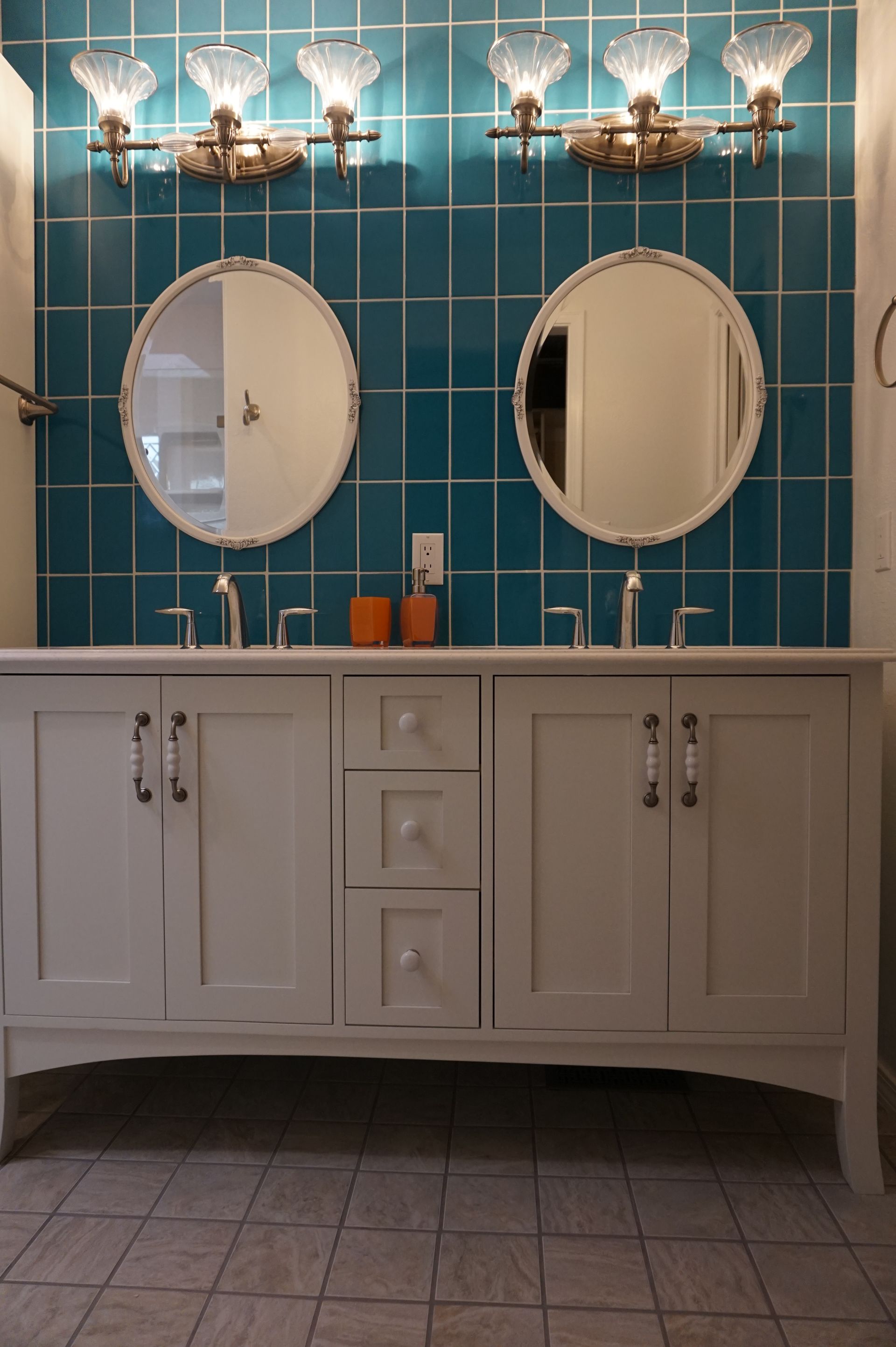 a bathroom with two sinks and two mirrors