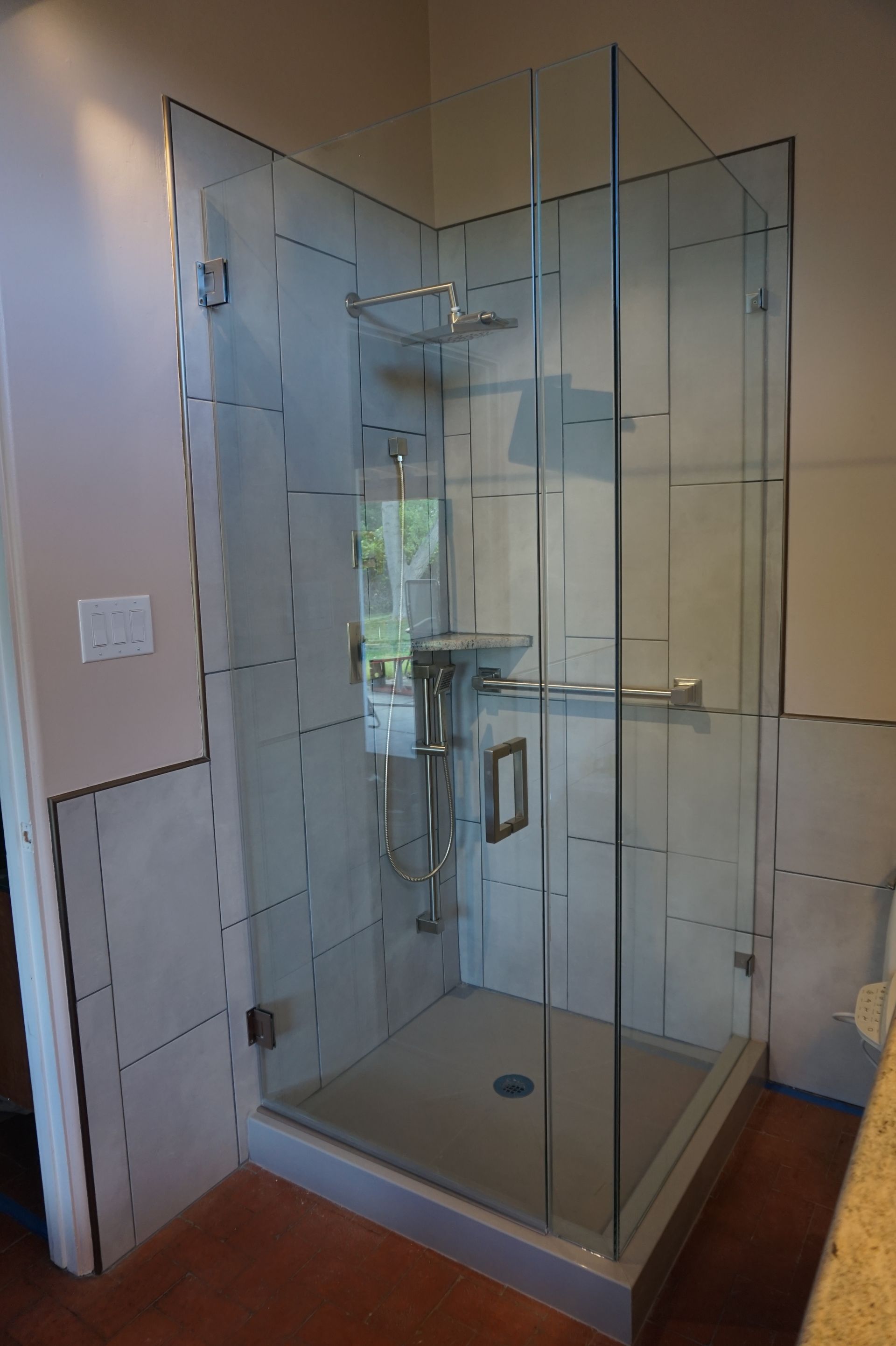 a bathroom with a walk in shower with a glass door