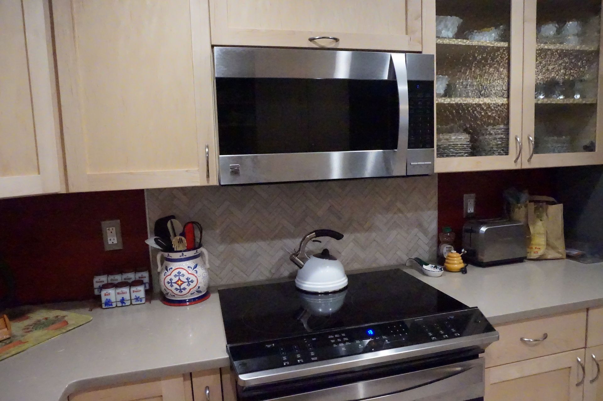 a kitchen with a stove top oven and a microwave