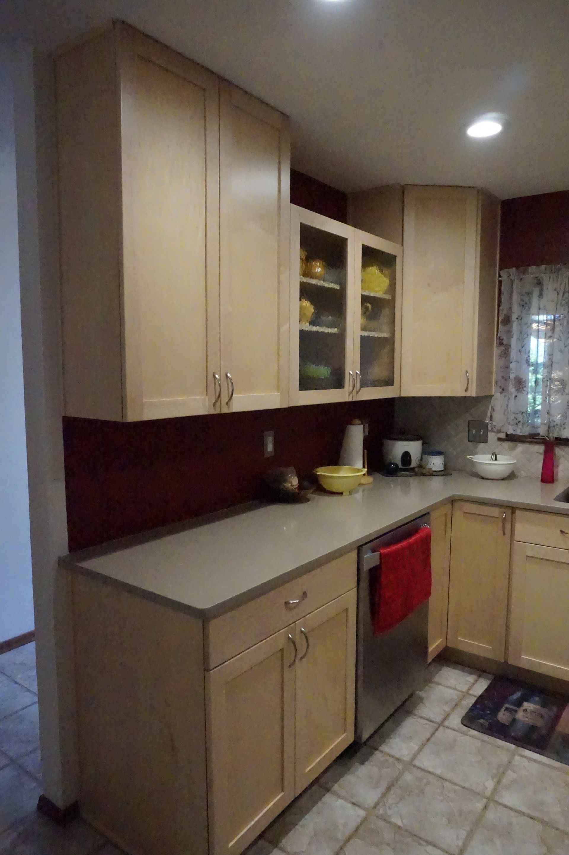 a kitchen with wooden cabinets and stainless steel appliances