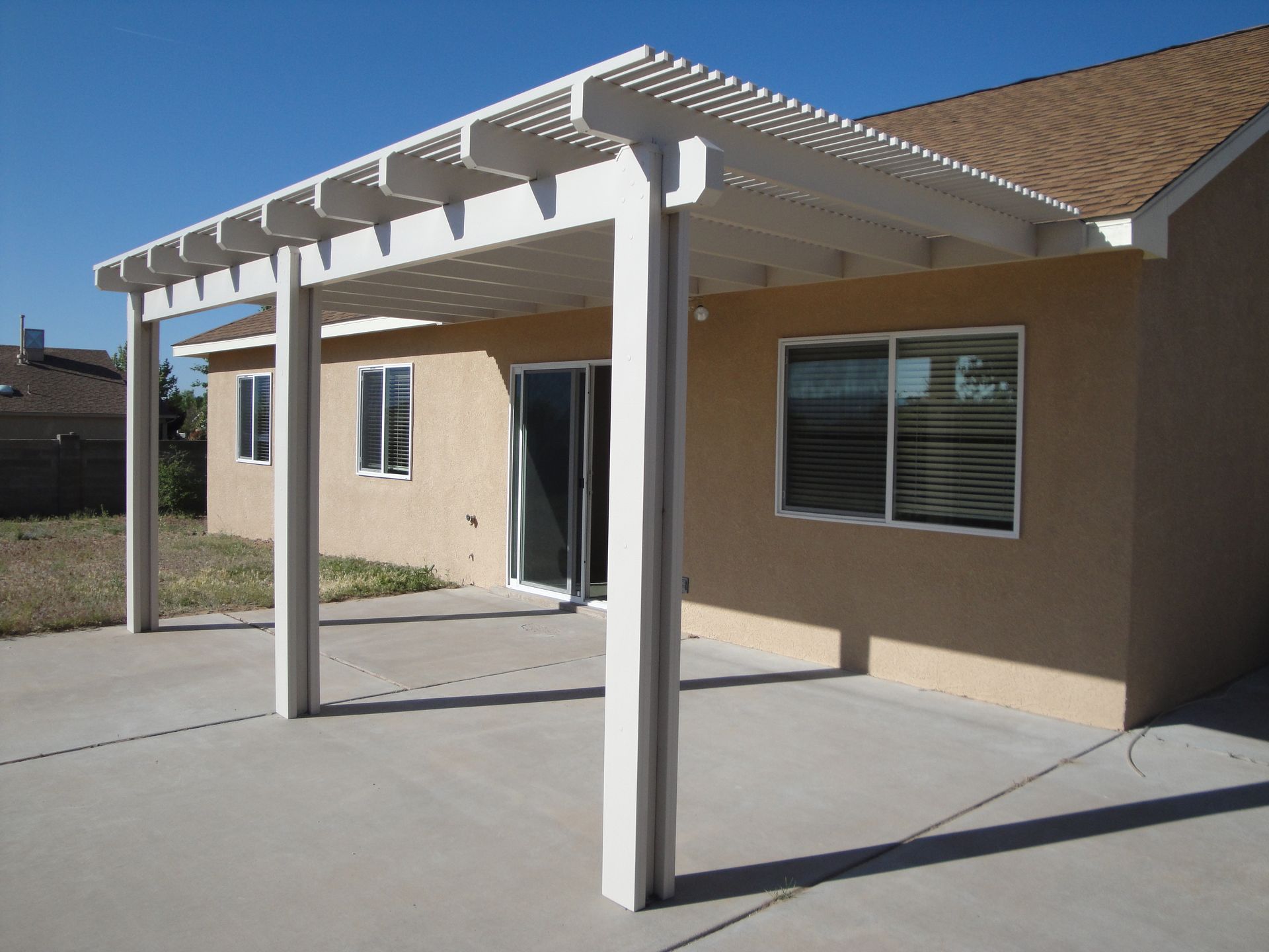 a house with a white pergola on top of it