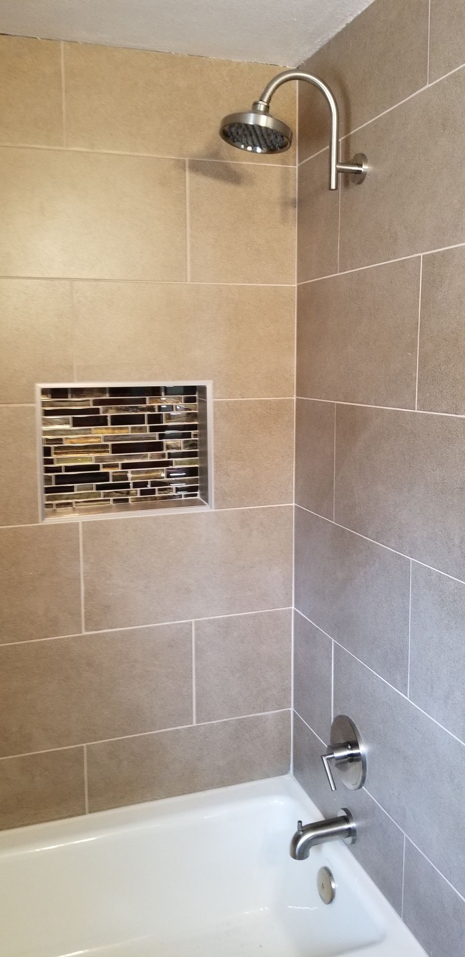 a bathroom with a bathtub and a shower head