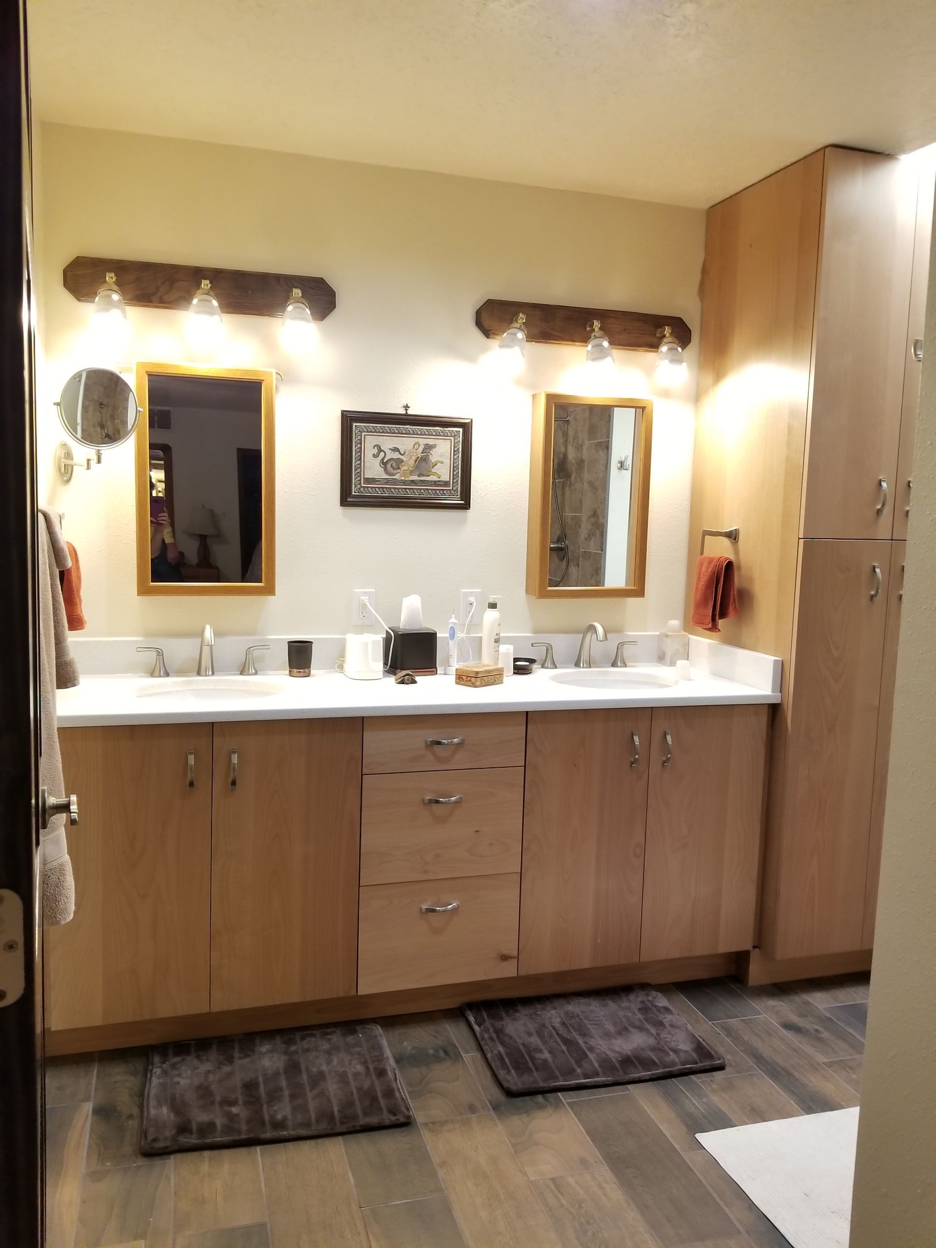 a bathroom with two sinks and two mirrors