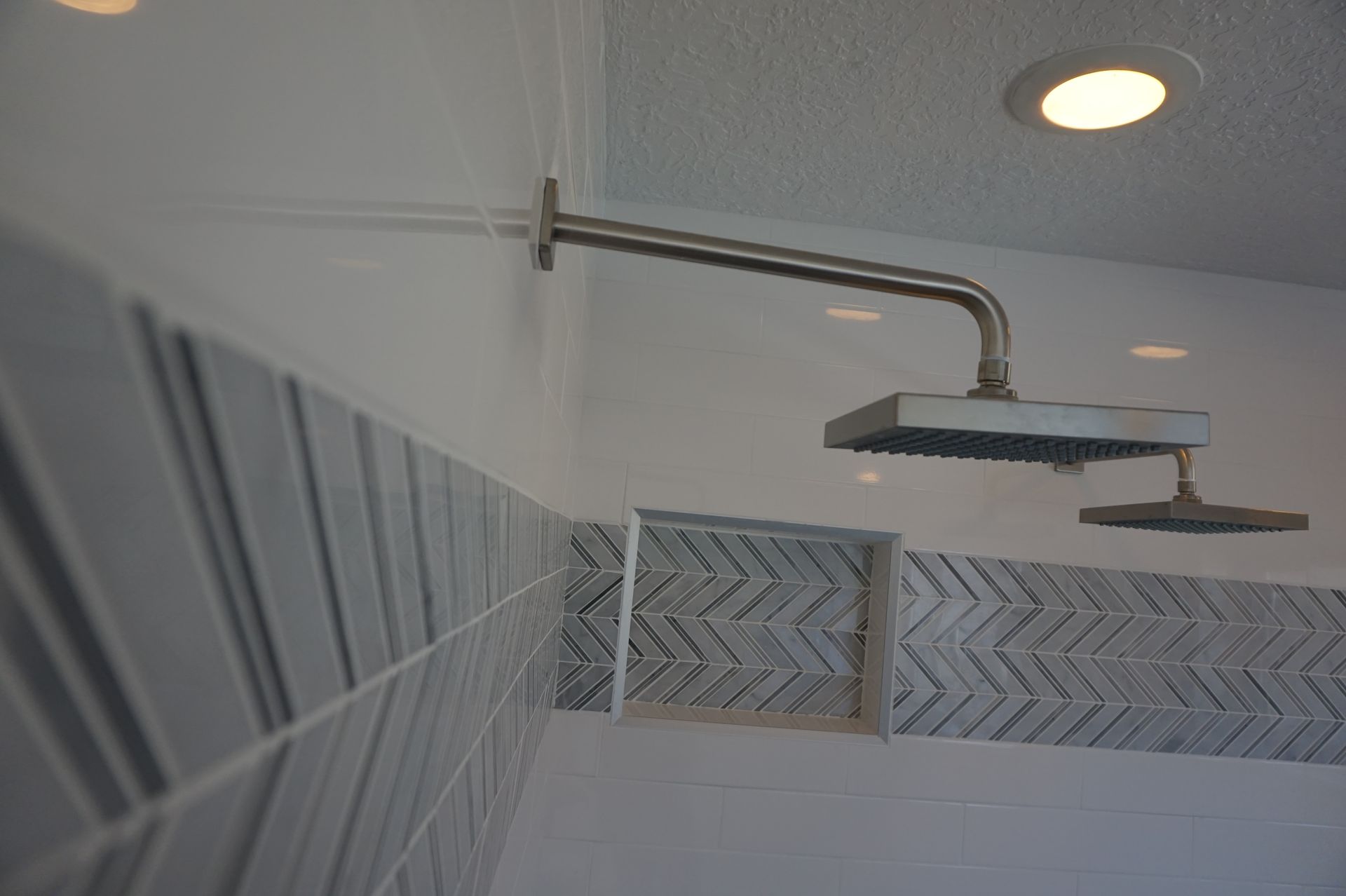 a shower head is hanging from the ceiling in a bathroom