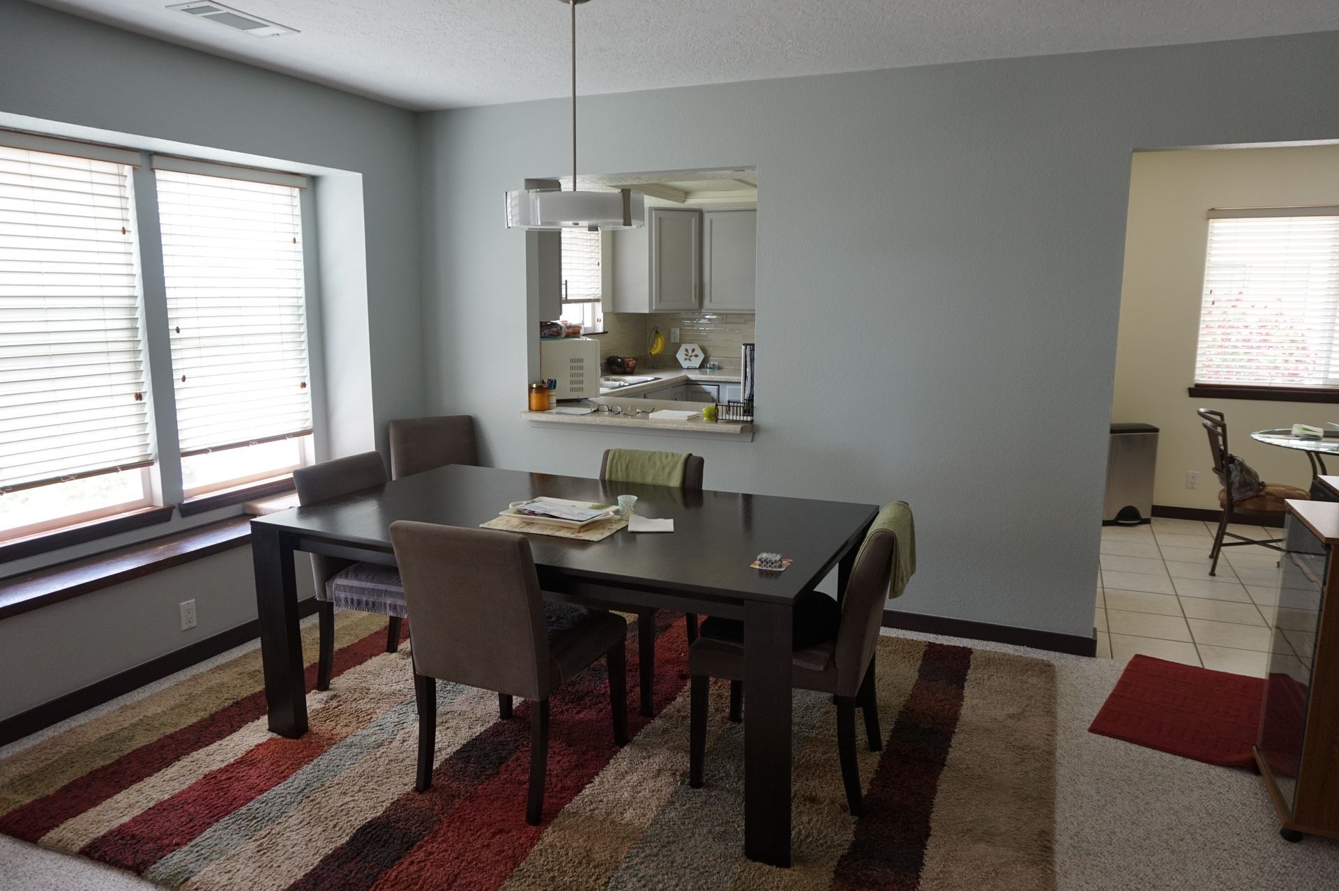 a dining room with a table and chairs and a rug