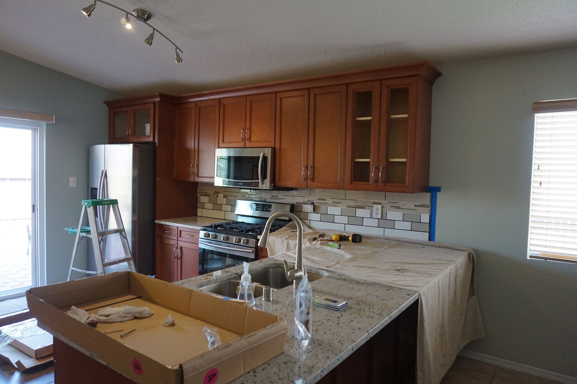 a kitchen with wooden cabinets and granite counter tops