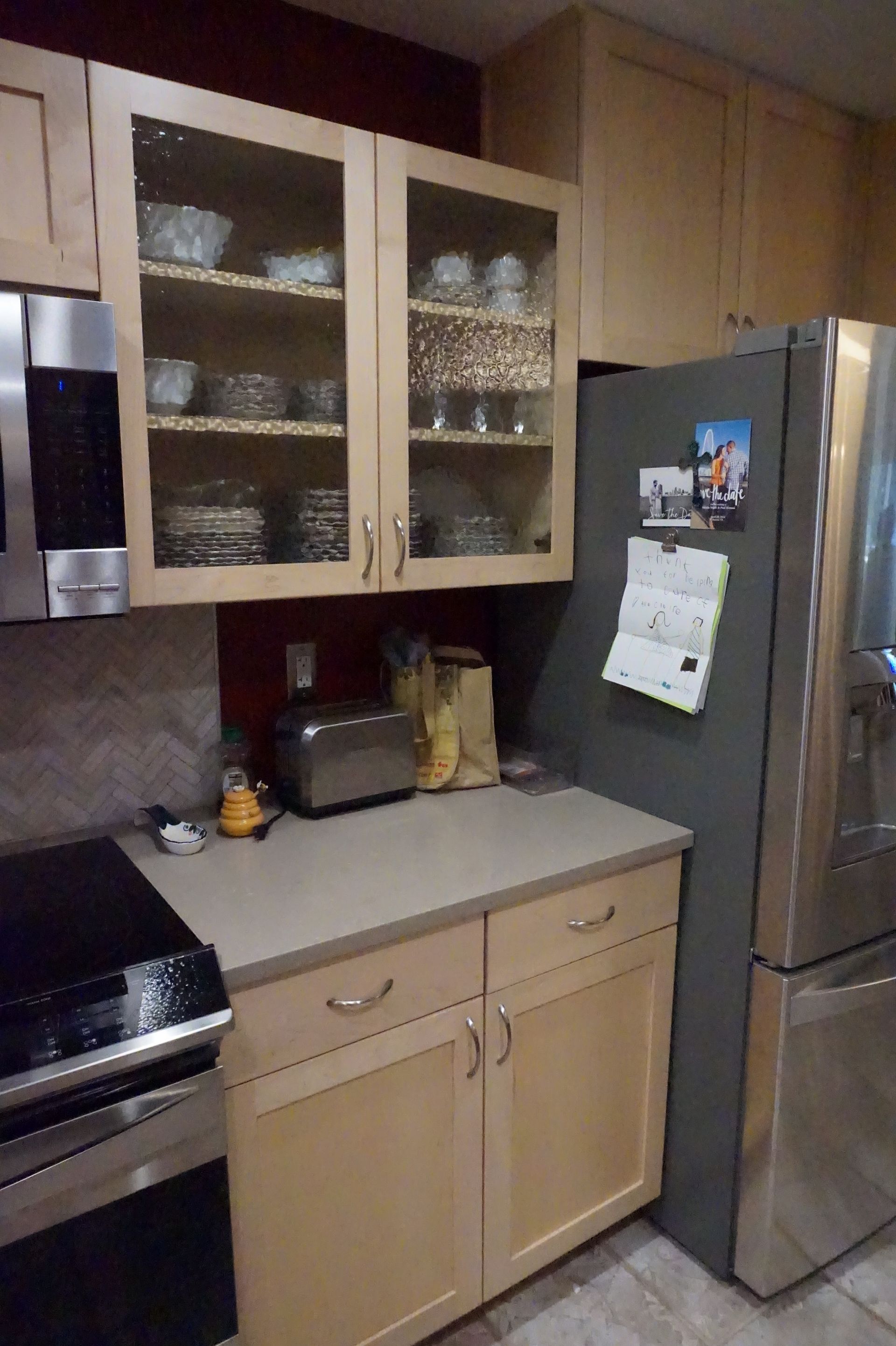 a kitchen with stainless steel appliances and wooden cabinets