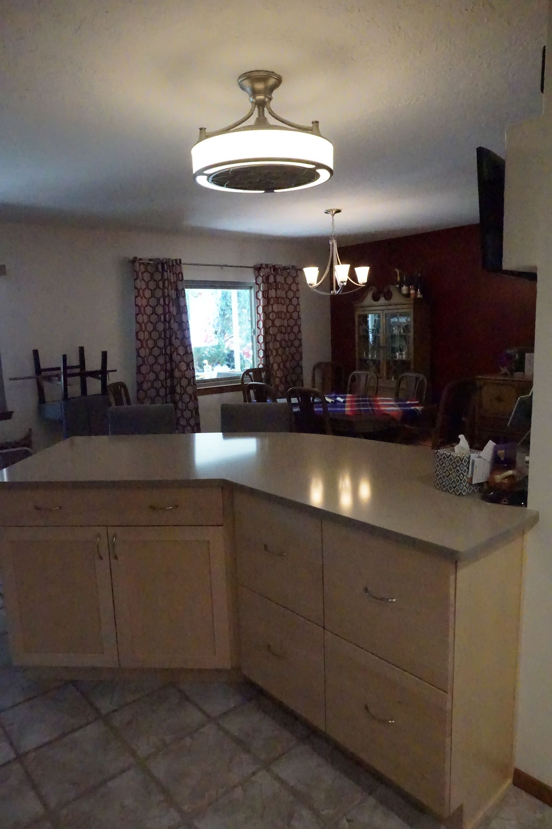 a kitchen with a large island and a ceiling fan