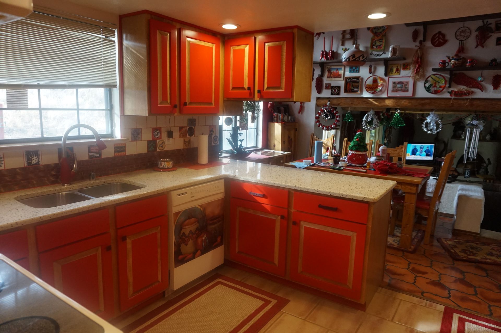 a kitchen with red cabinets and granite counter tops