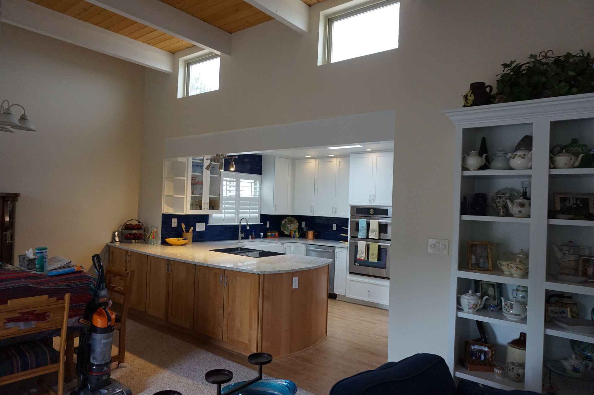 a living room with a kitchen in the background