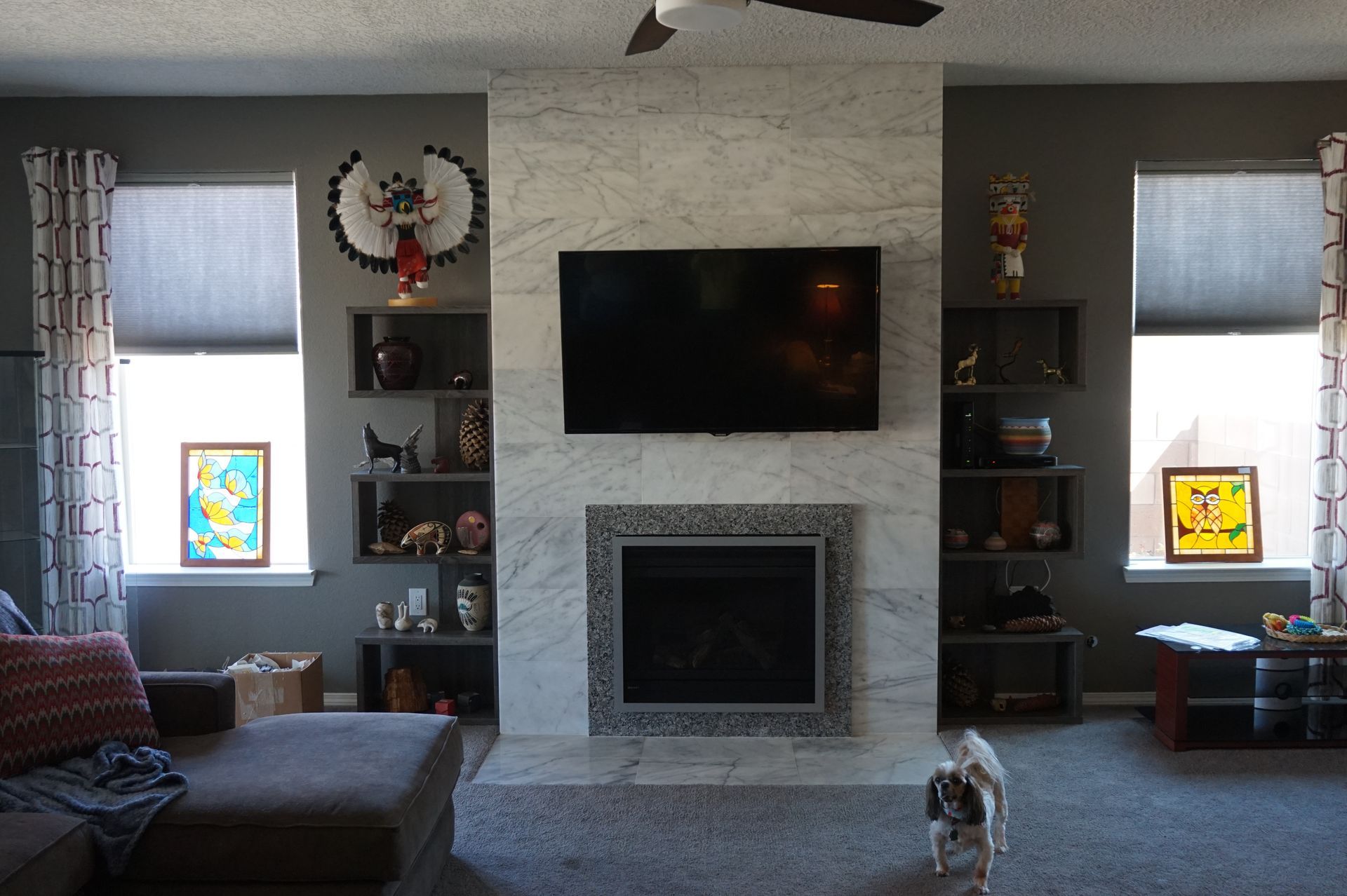 a living room with a fireplace and a flat screen tv