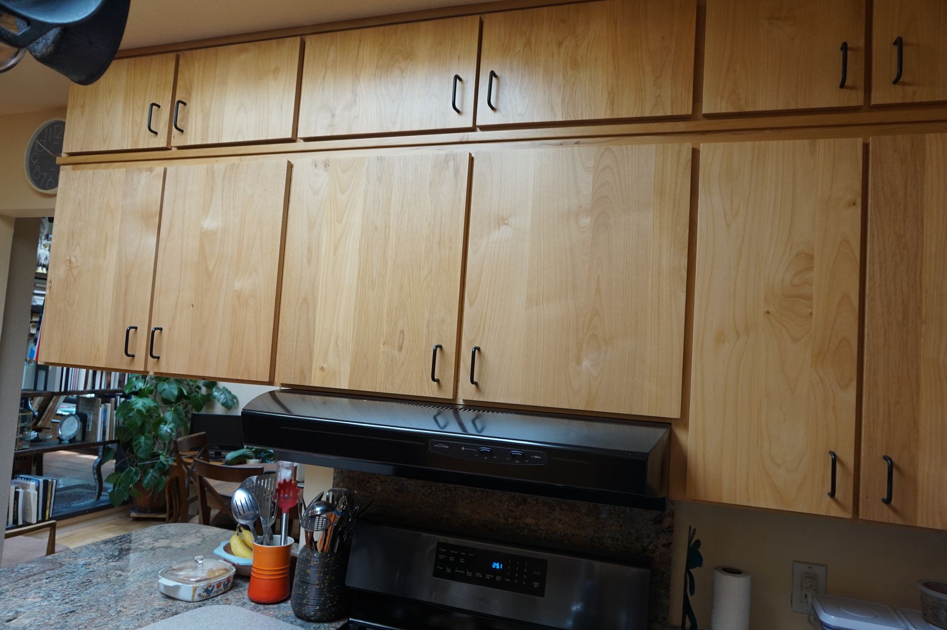 a kitchen with wooden cabinets and a stove top oven