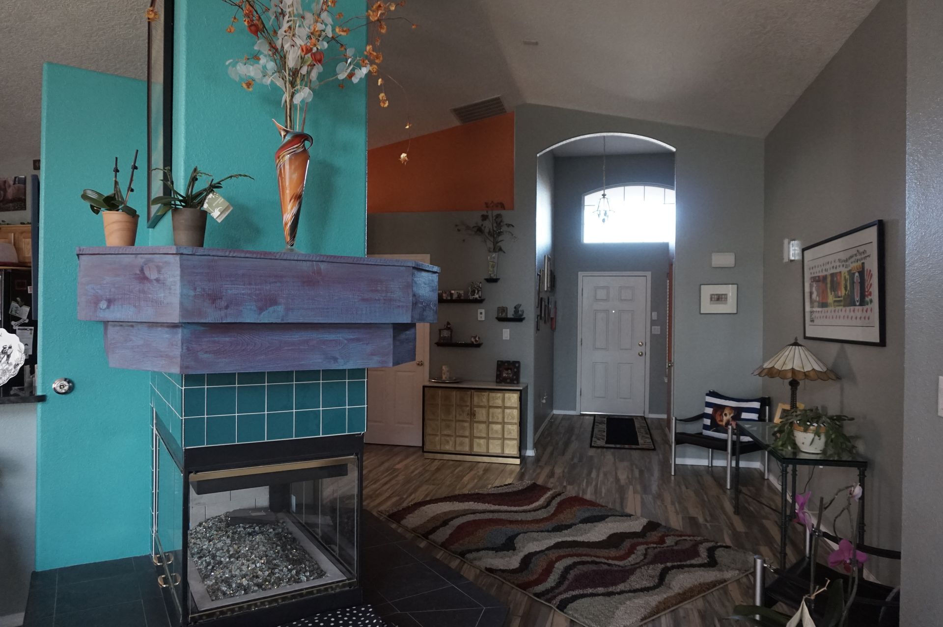 a living room with a fireplace and a rug