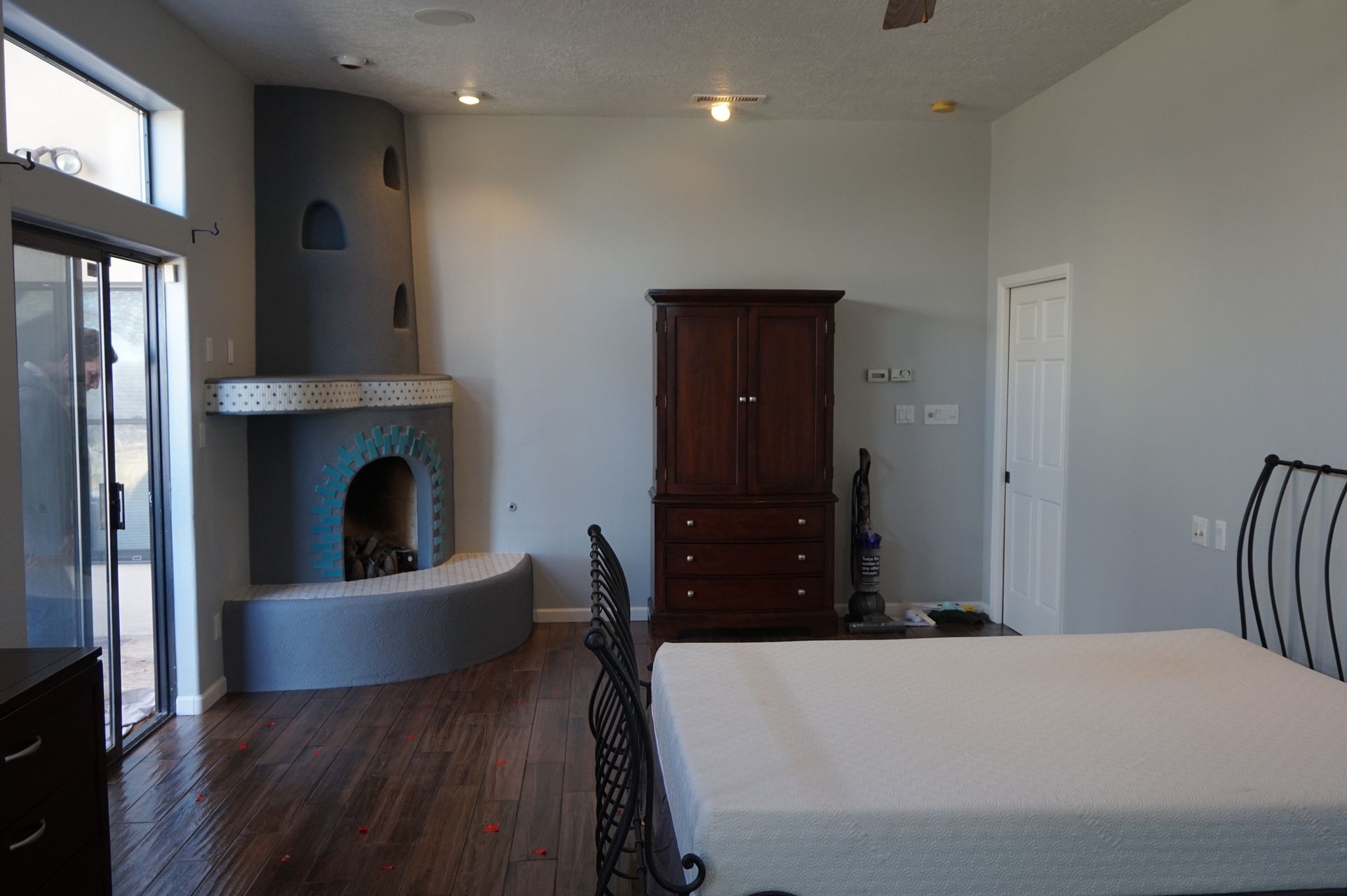 a large room with a fireplace and a bed