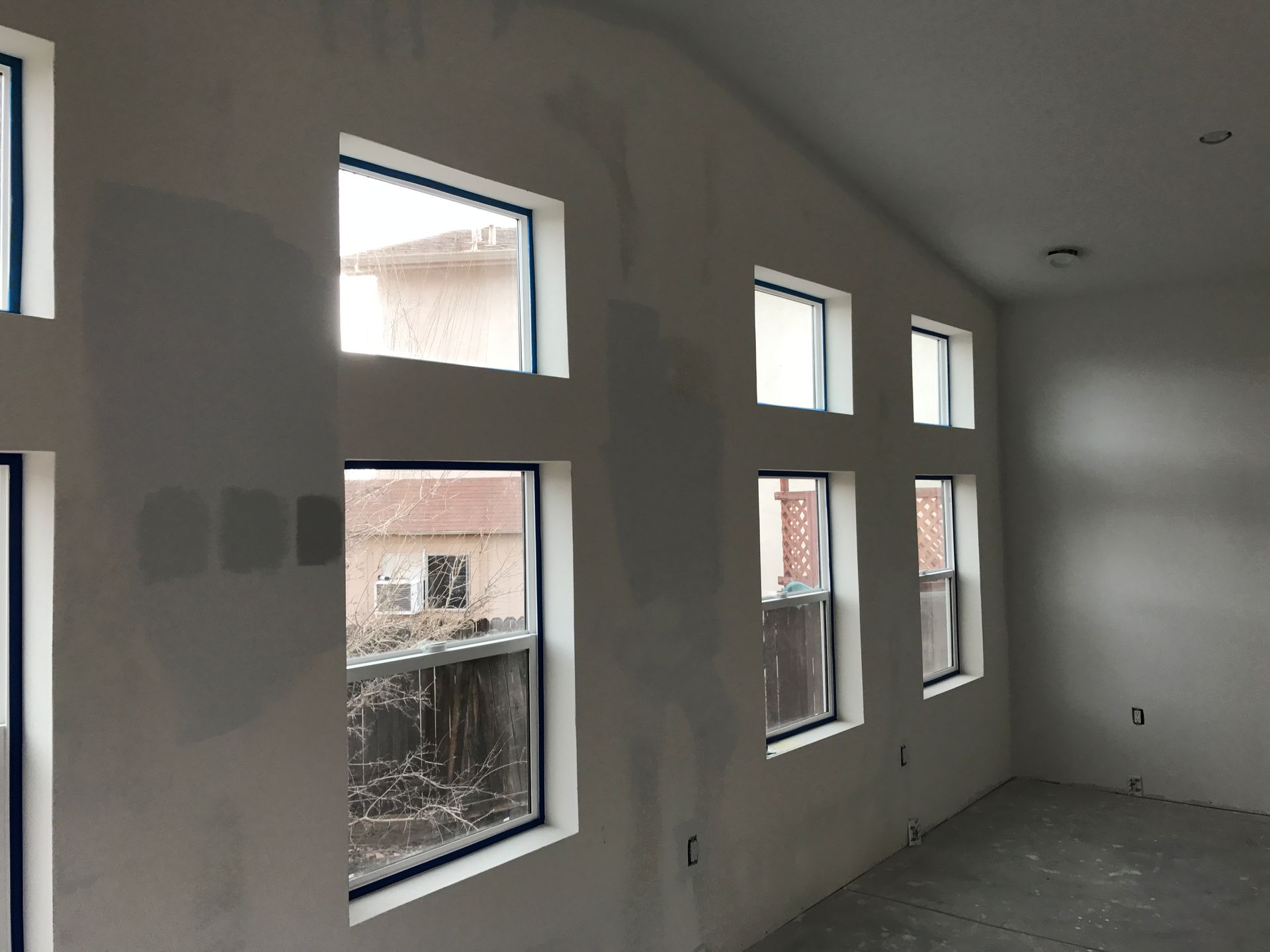 a room with a lot of windows and a building in the background