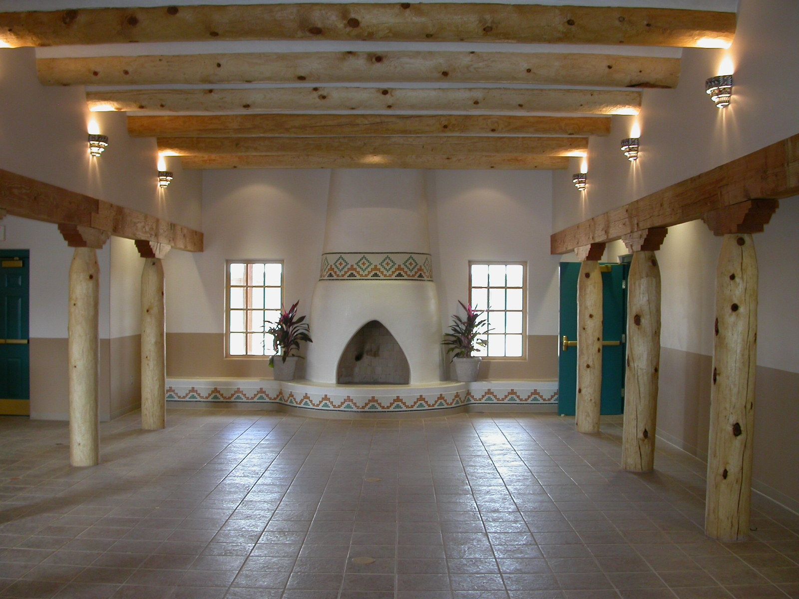 a large room with a fireplace and wooden beams