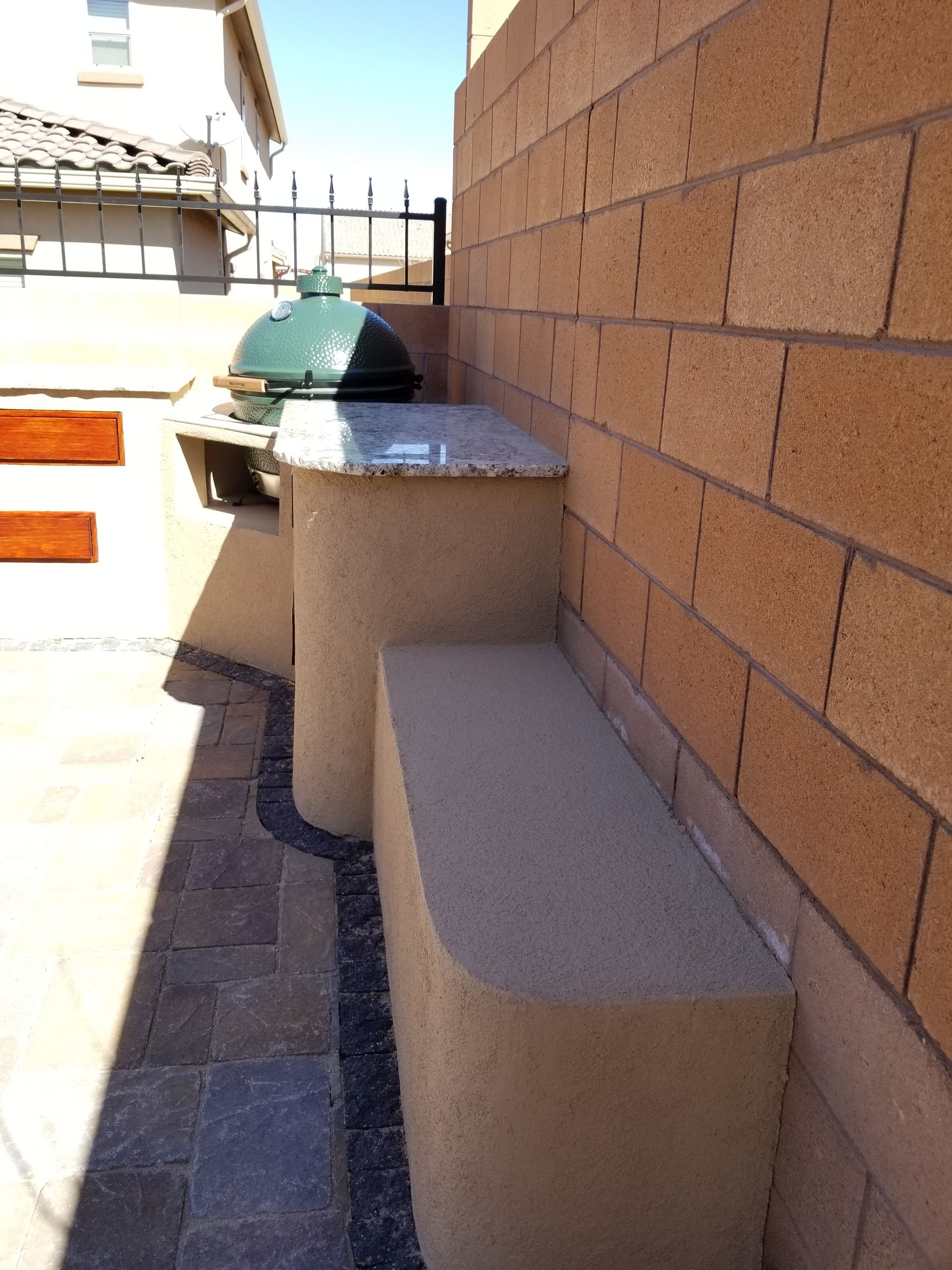 a brick wall with a bench in front of it