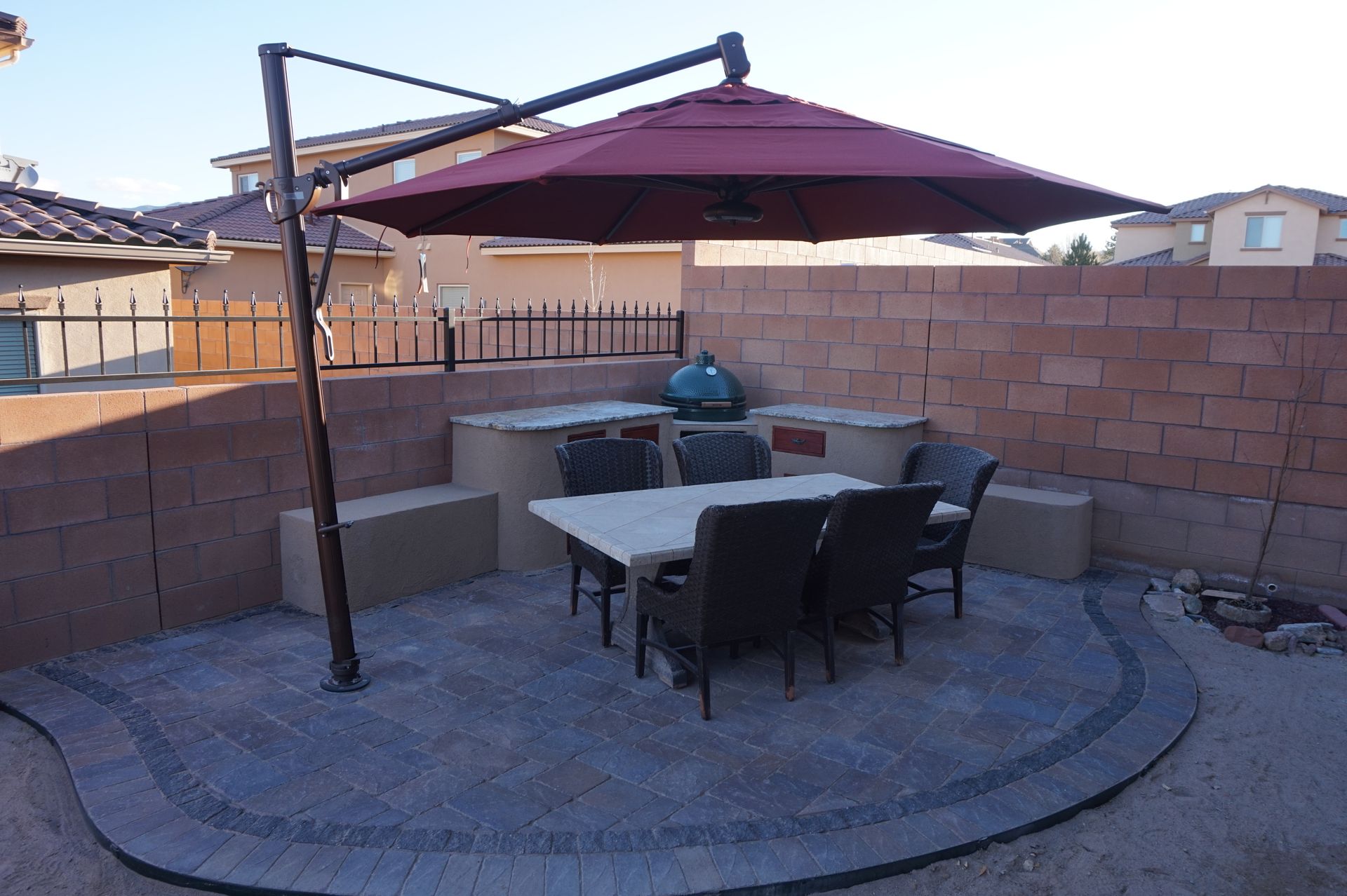 a patio with a table and chairs under an umbrella