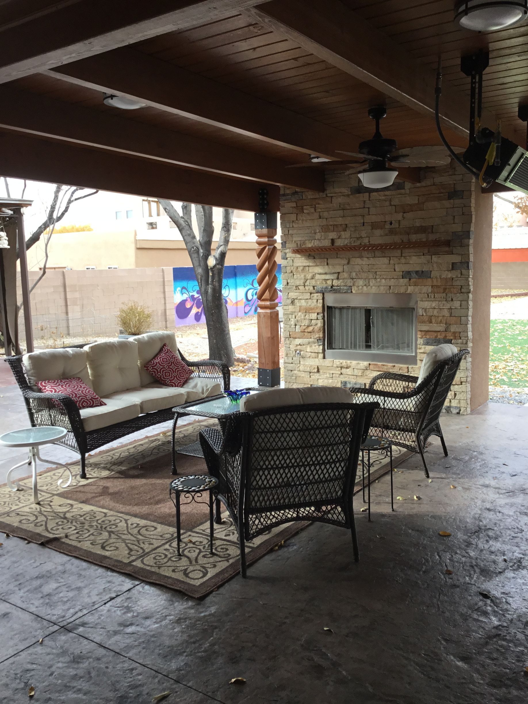 a living room with a couch, chairs and a fireplace
