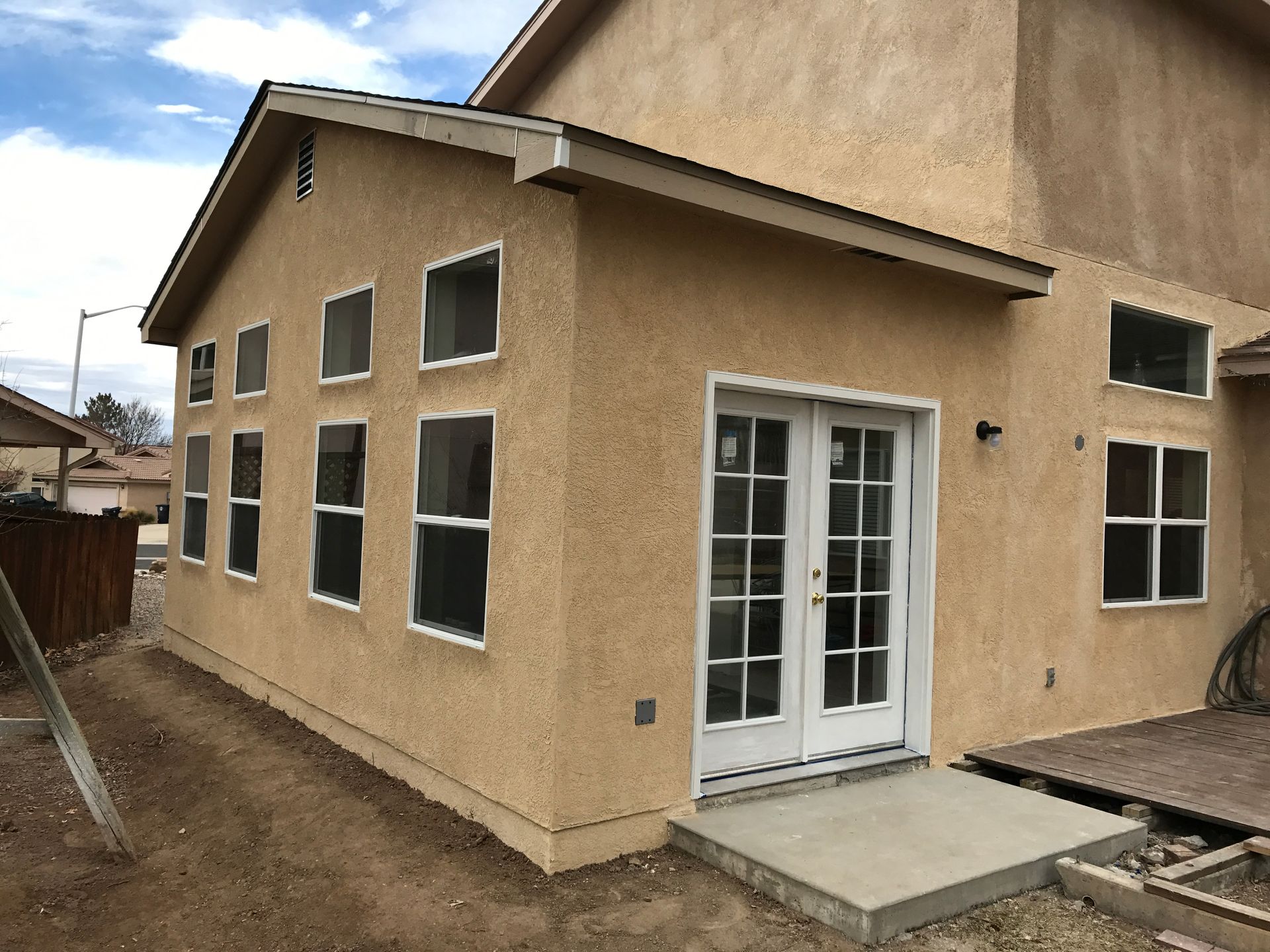 a house with a lot of windows and french doors