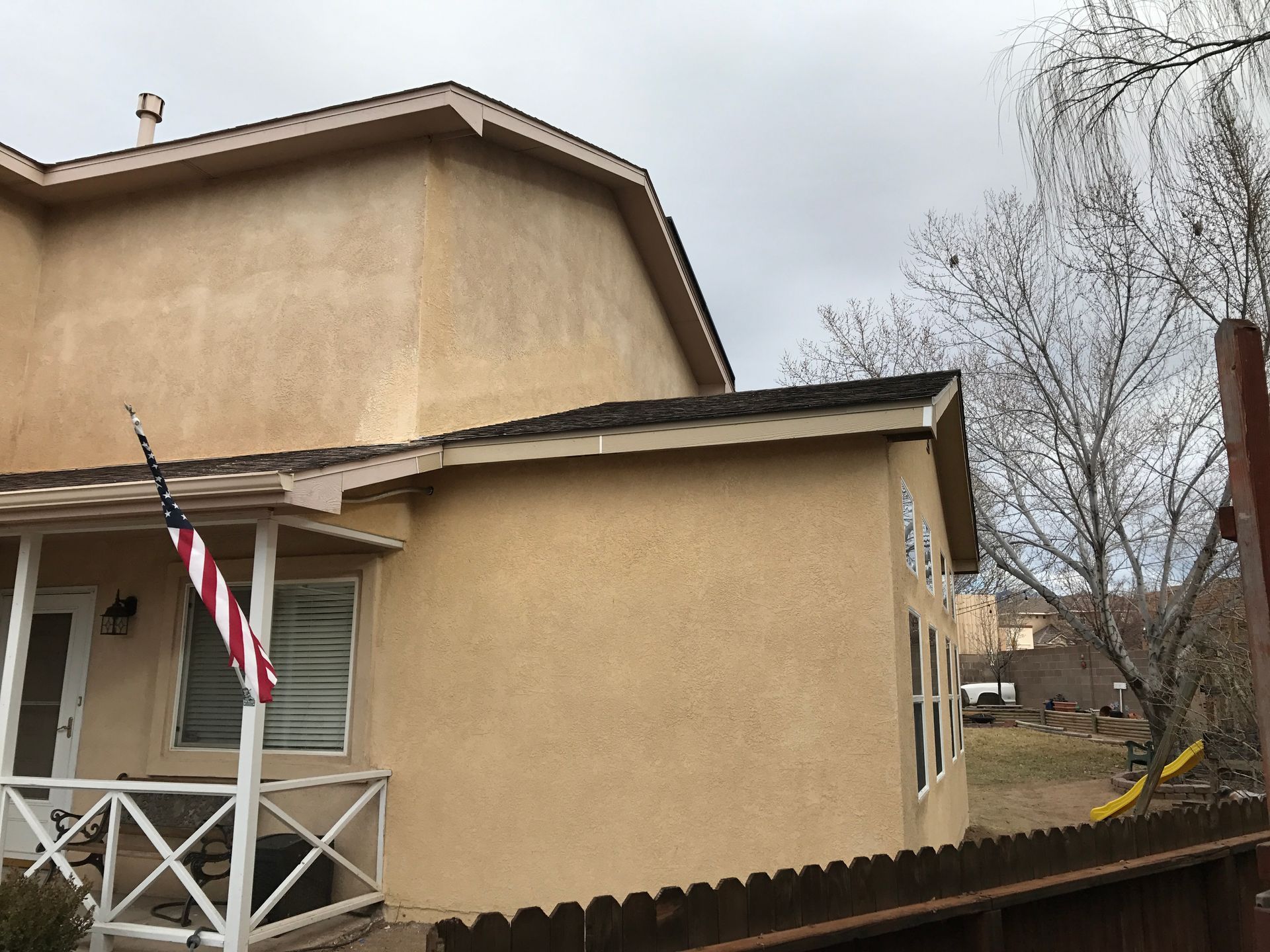 a house with a porch and an American flag on it