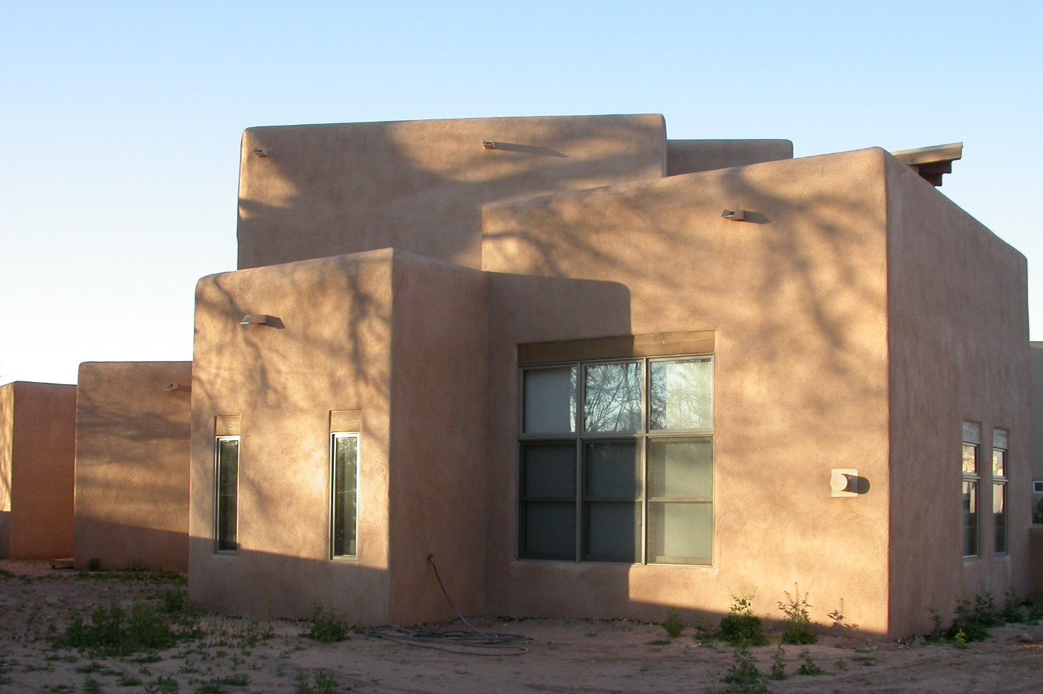 a house with a lot of windows in the desert