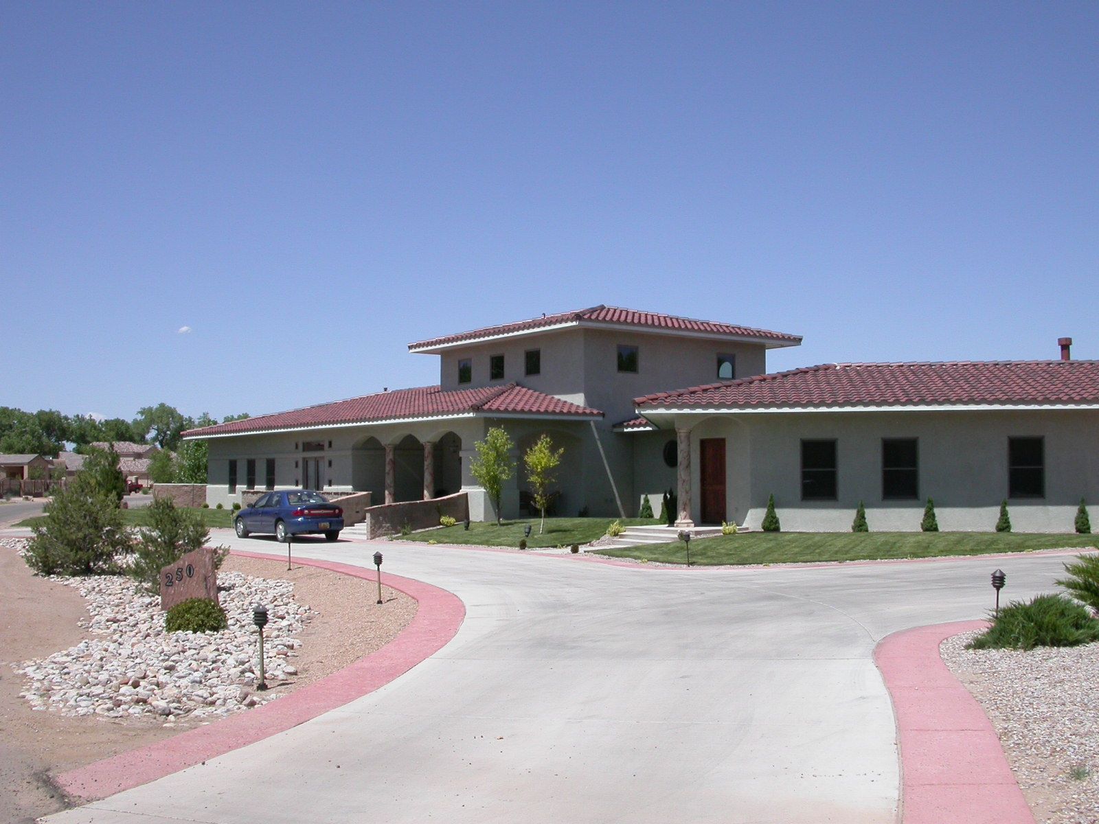 a car is parked in front of a large house