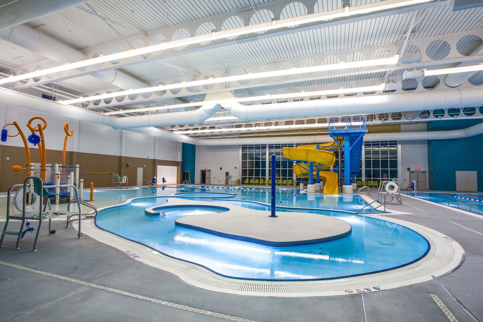 a large indoor swimming pool with a water slide