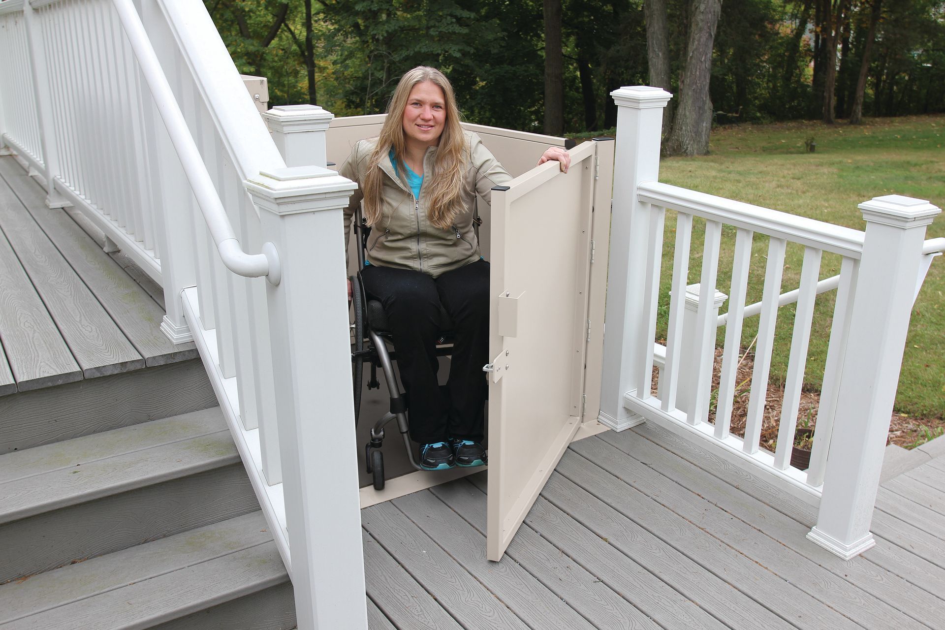 Smiling woman on a wheelchair lift