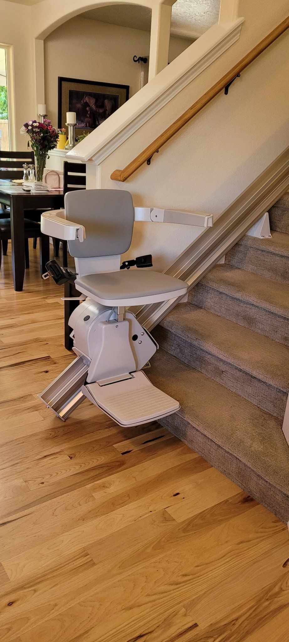 A stair lift is sitting on top of a set of stairs in a living room