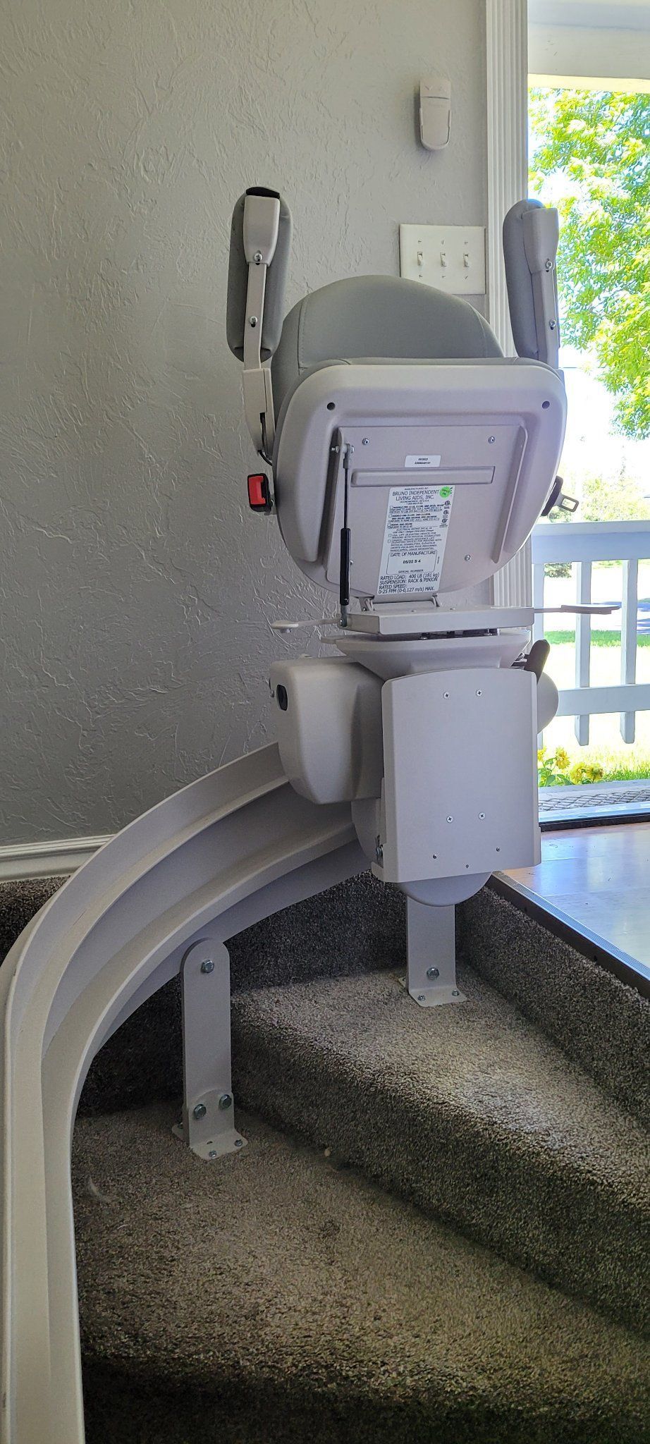 A stair lift is sitting on top of a set of curved stairs