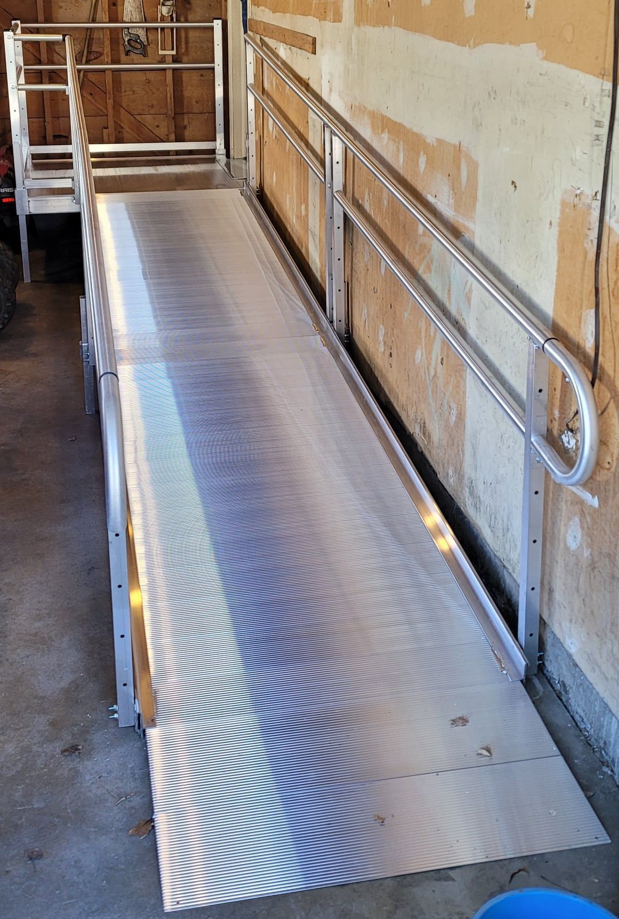 An aluminum ramp with a metal railing