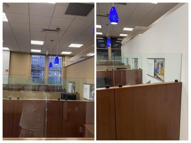 Two photos of a bank office with wood desks, glass dividers, and blue pendant lights.
