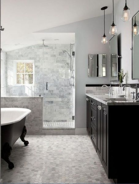 Bathroom with clawfoot tub, shower, black vanity, and pendant lights. Light gray and white color scheme.
