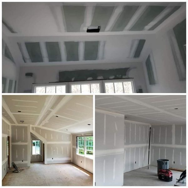 Drywall installation in progress on walls and ceiling of a home.