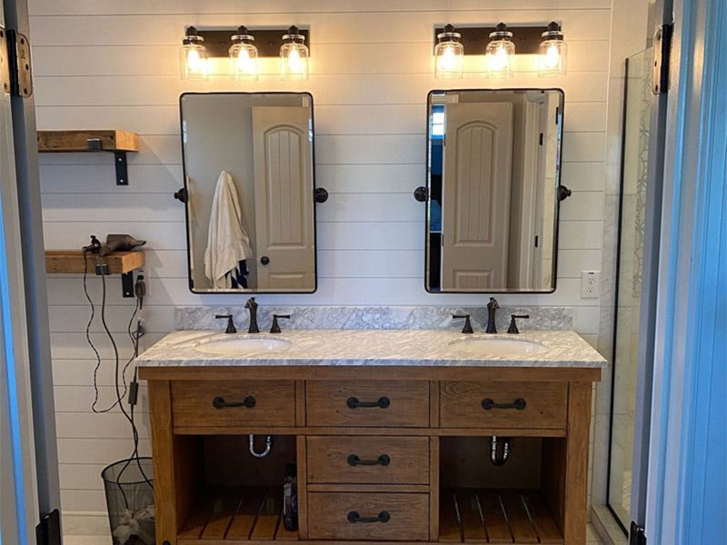 A bathroom with two sinks and two mirrors.