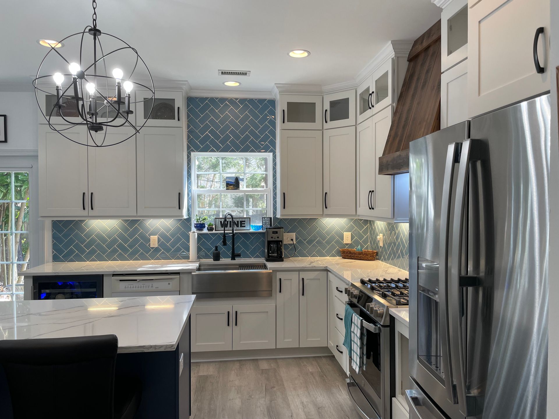 A kitchen with white cabinets and stainless steel appliances.