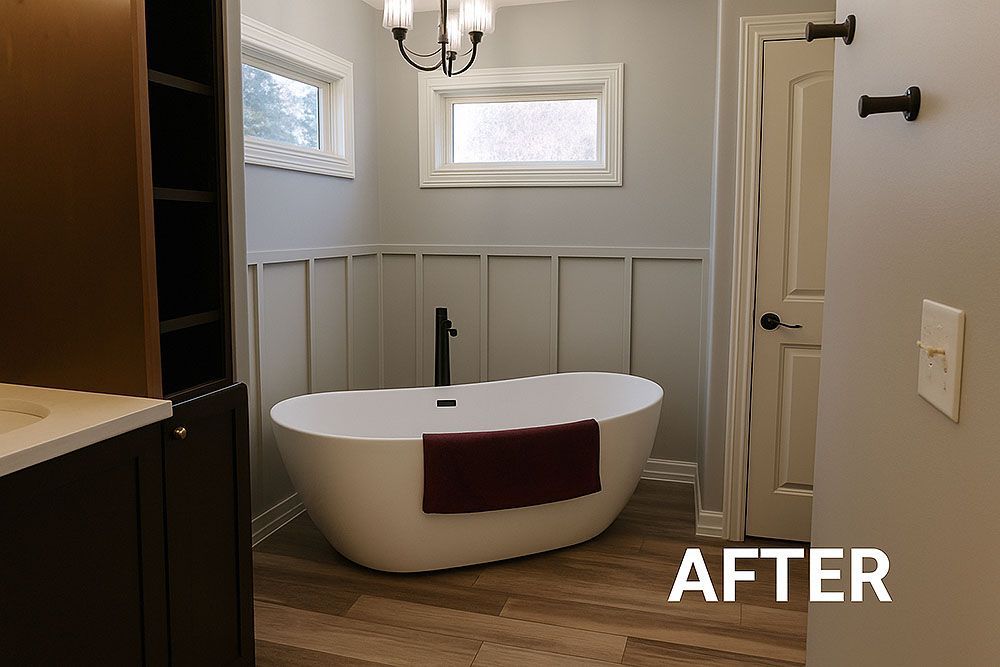 Modern bathroom with a white tub, light gray walls, wood-look floor, and a dark brown cabinet.