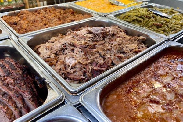 there are many different types of food in the trays .