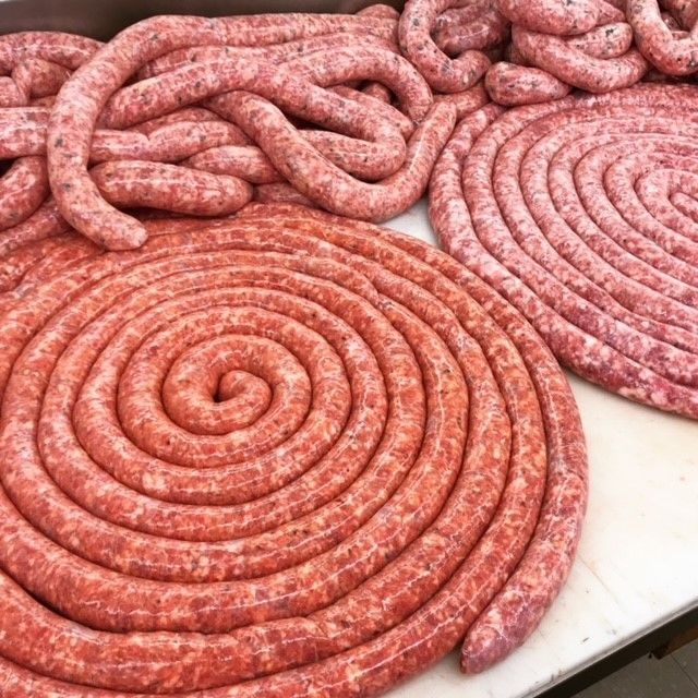 a bunch of sausages are arranged in a spiral on a table