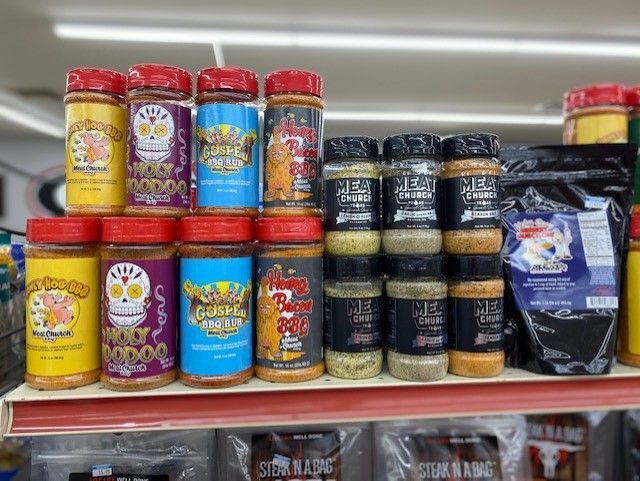 a shelf filled with lots of different types of spices .